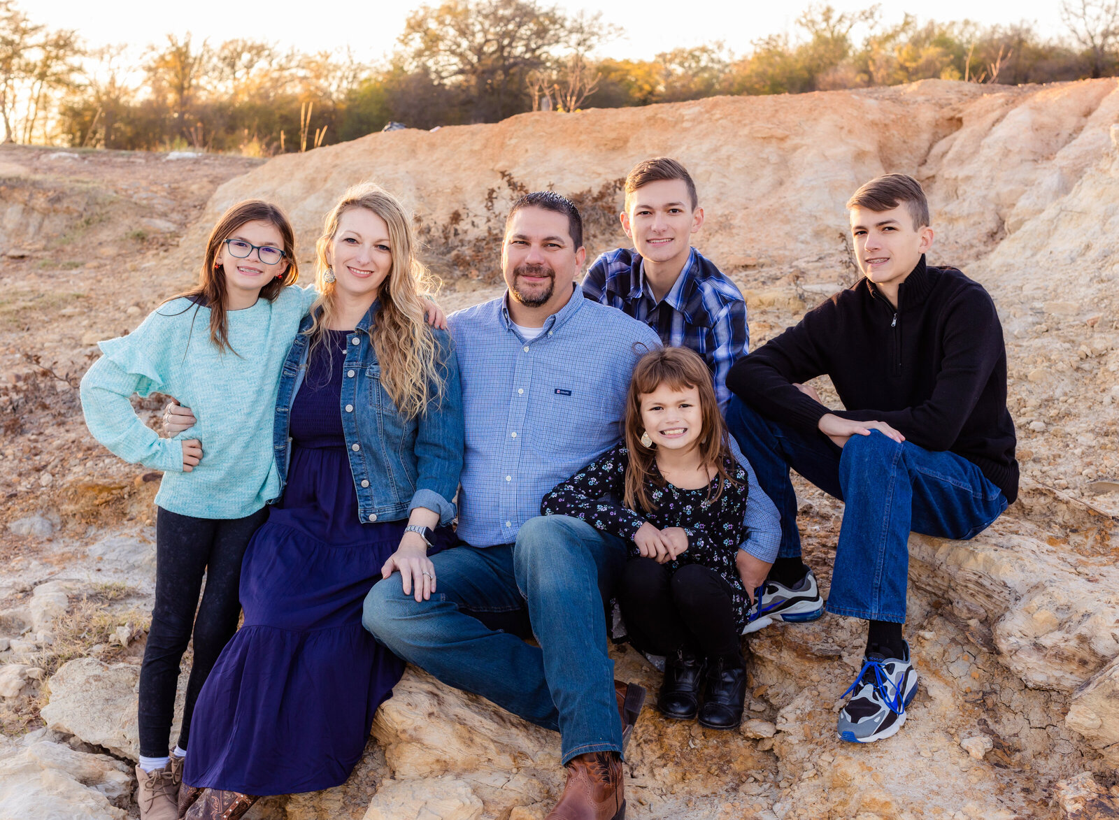 family seated on rocks