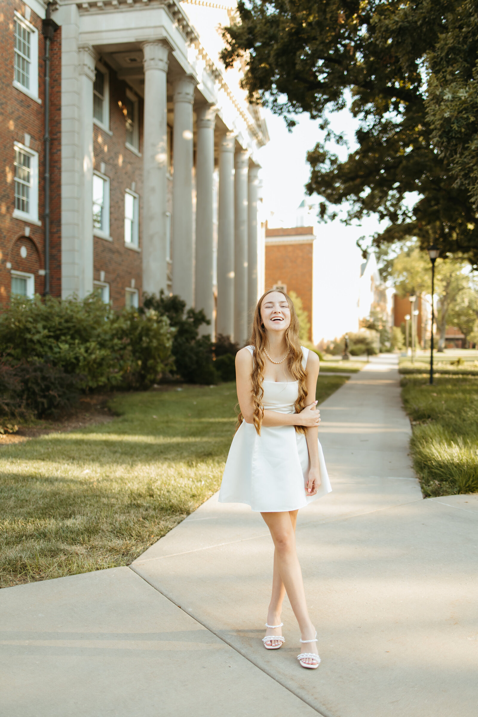 High school senior poses at wichita state university for senior photos with Ashley Cole Photography