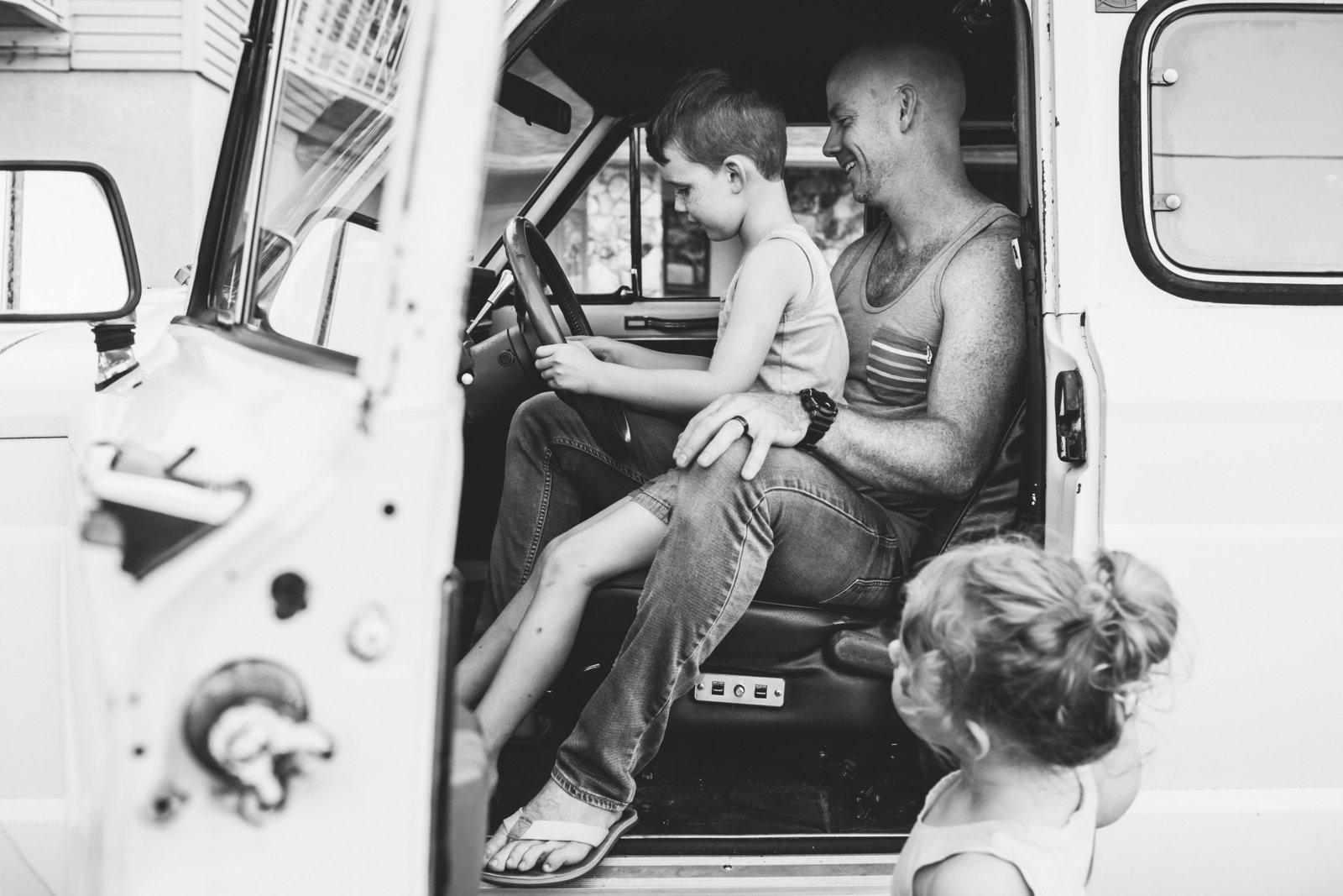 Dad and young son in old jeep for family photos