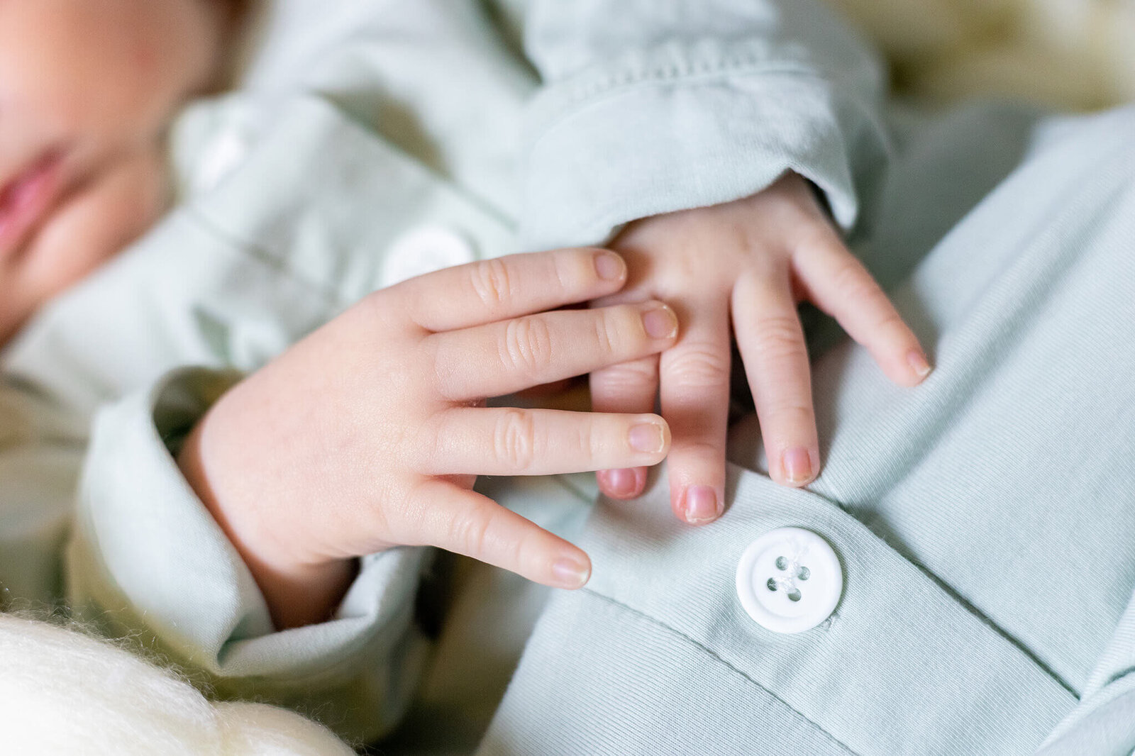 A close-up of a newborn boy's hands.