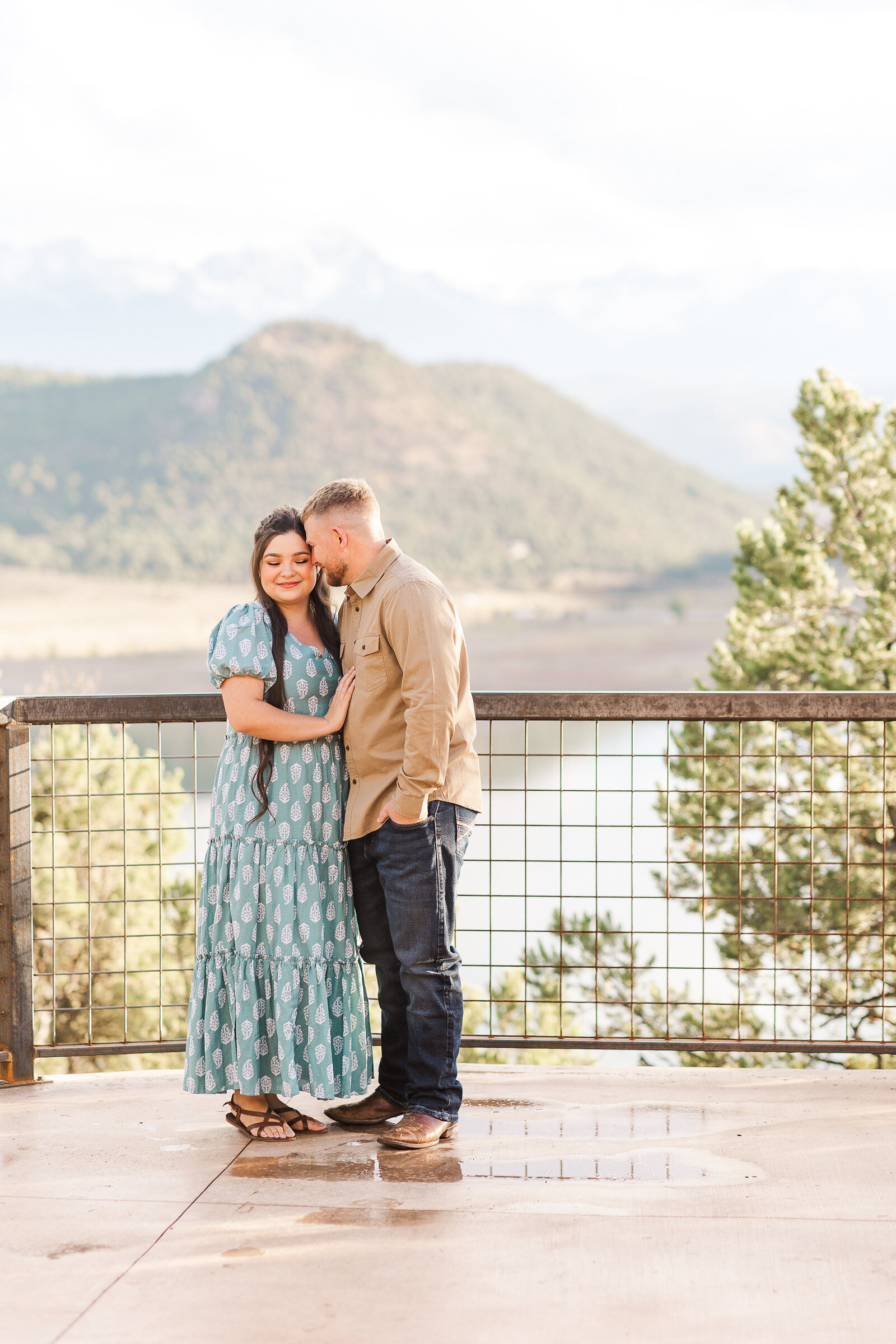 boyfriend nuzzles his nose to girlfriends temple