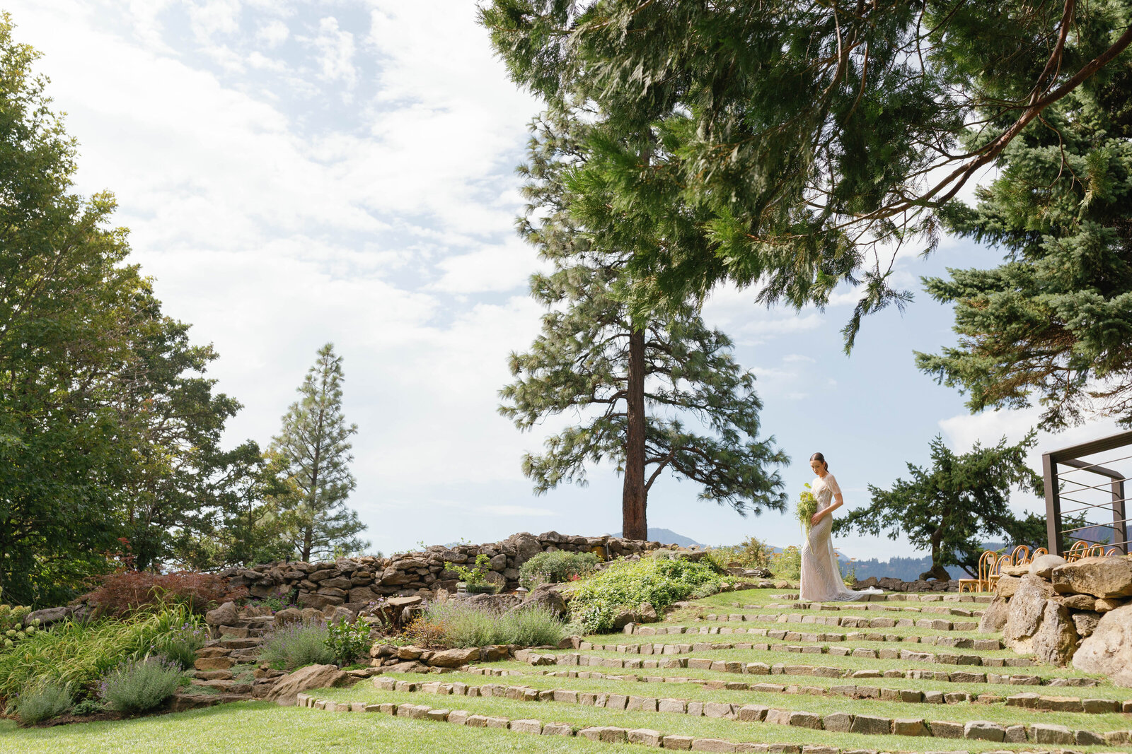 Bride walking down stone steps to first look at The Griffin House in Hood River.