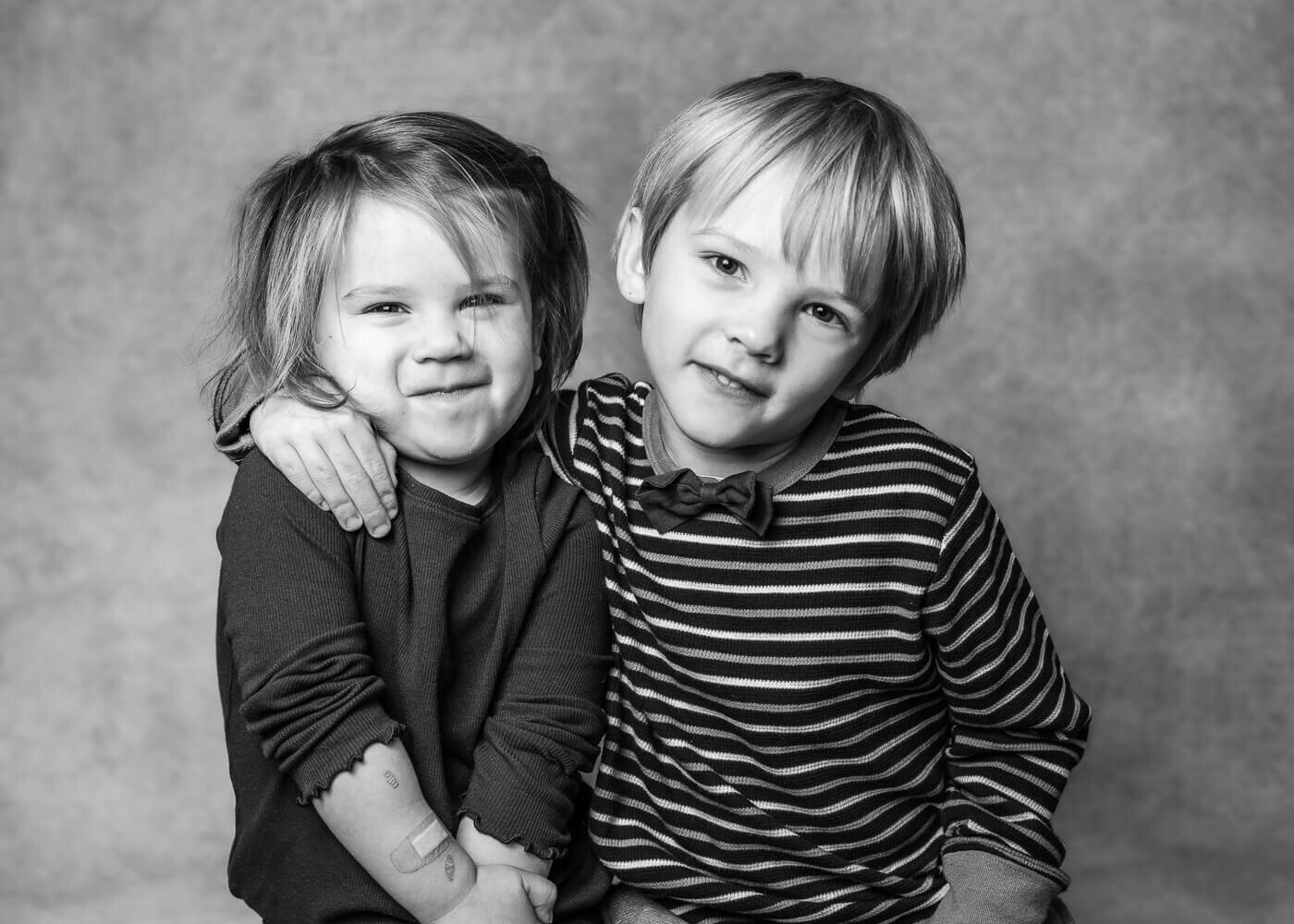 Two kids pose together.