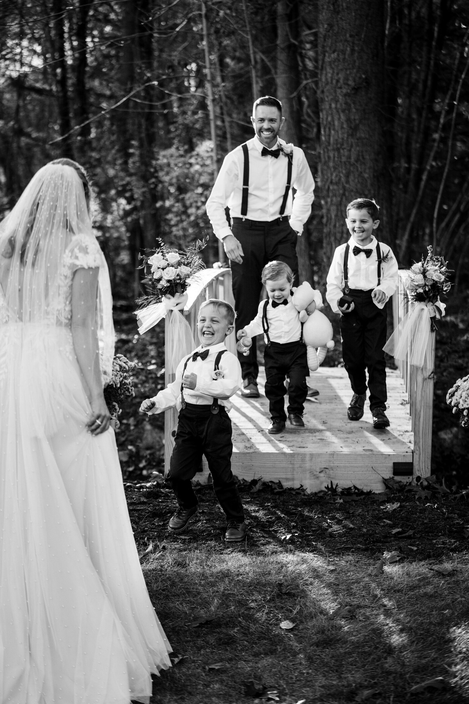 little boys run to woman in wedding dress at elopement
