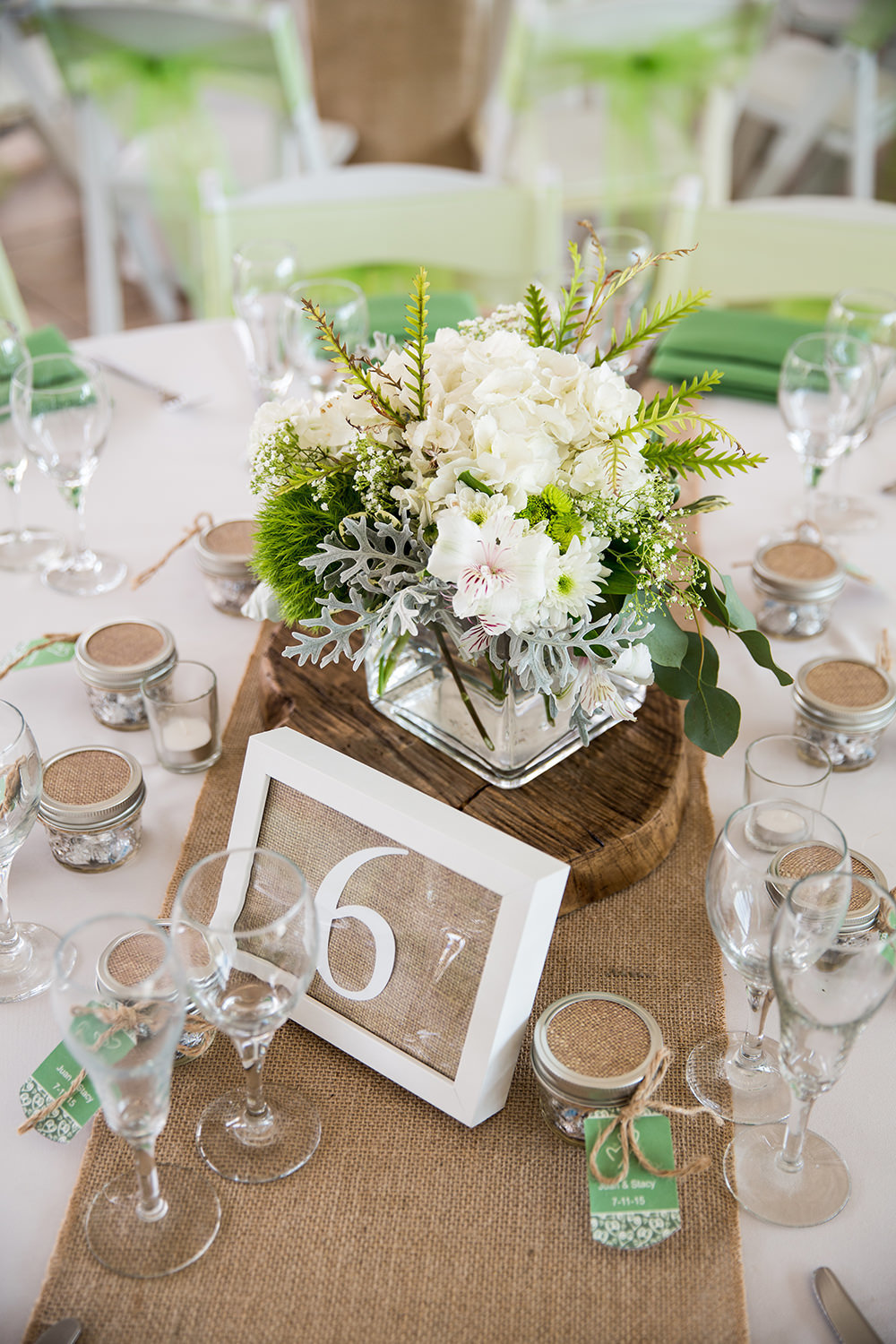 centerpiece with green and white flowers rustic wood