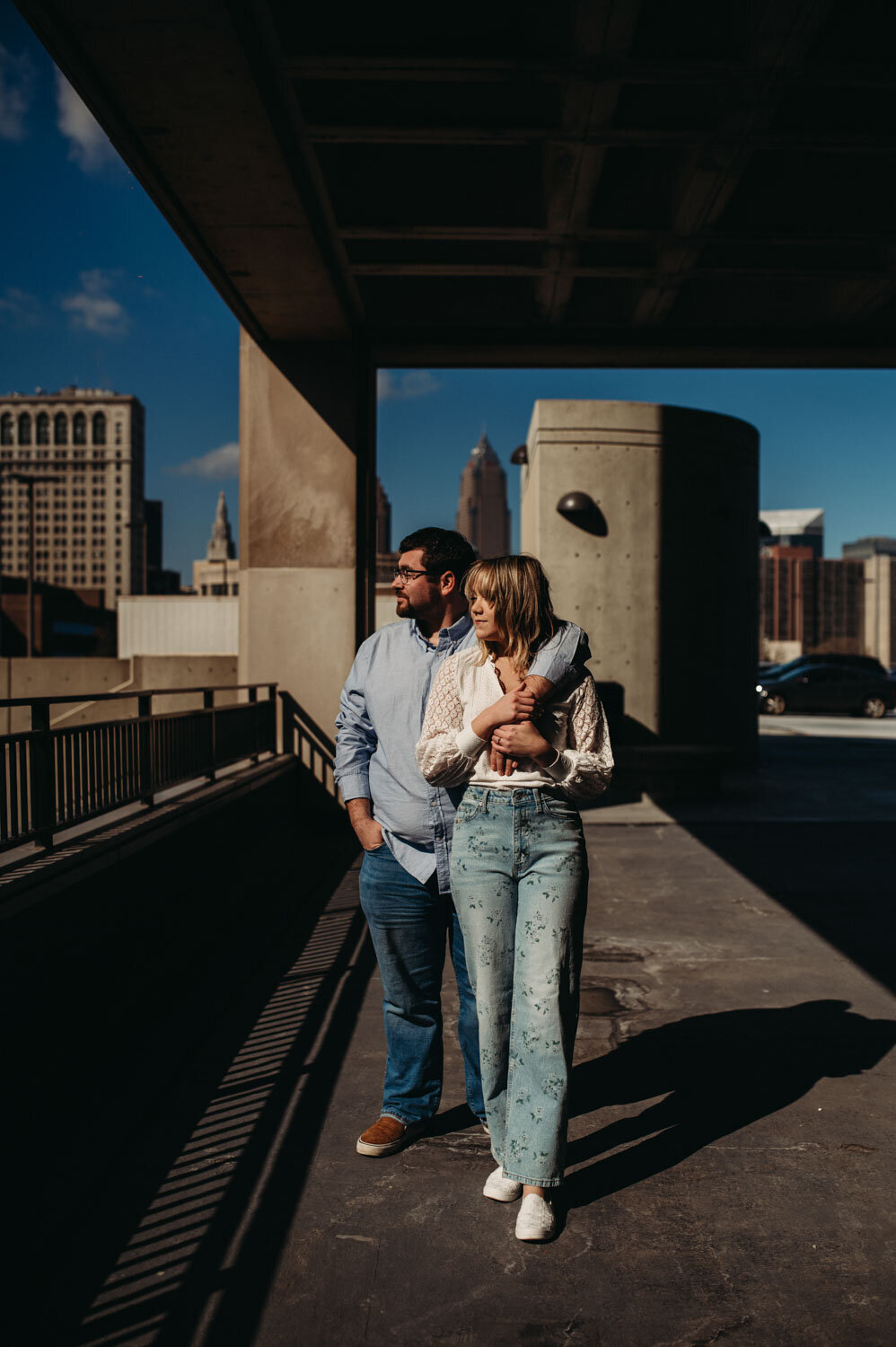 Couple stand in morning sun in downtown Cleveland