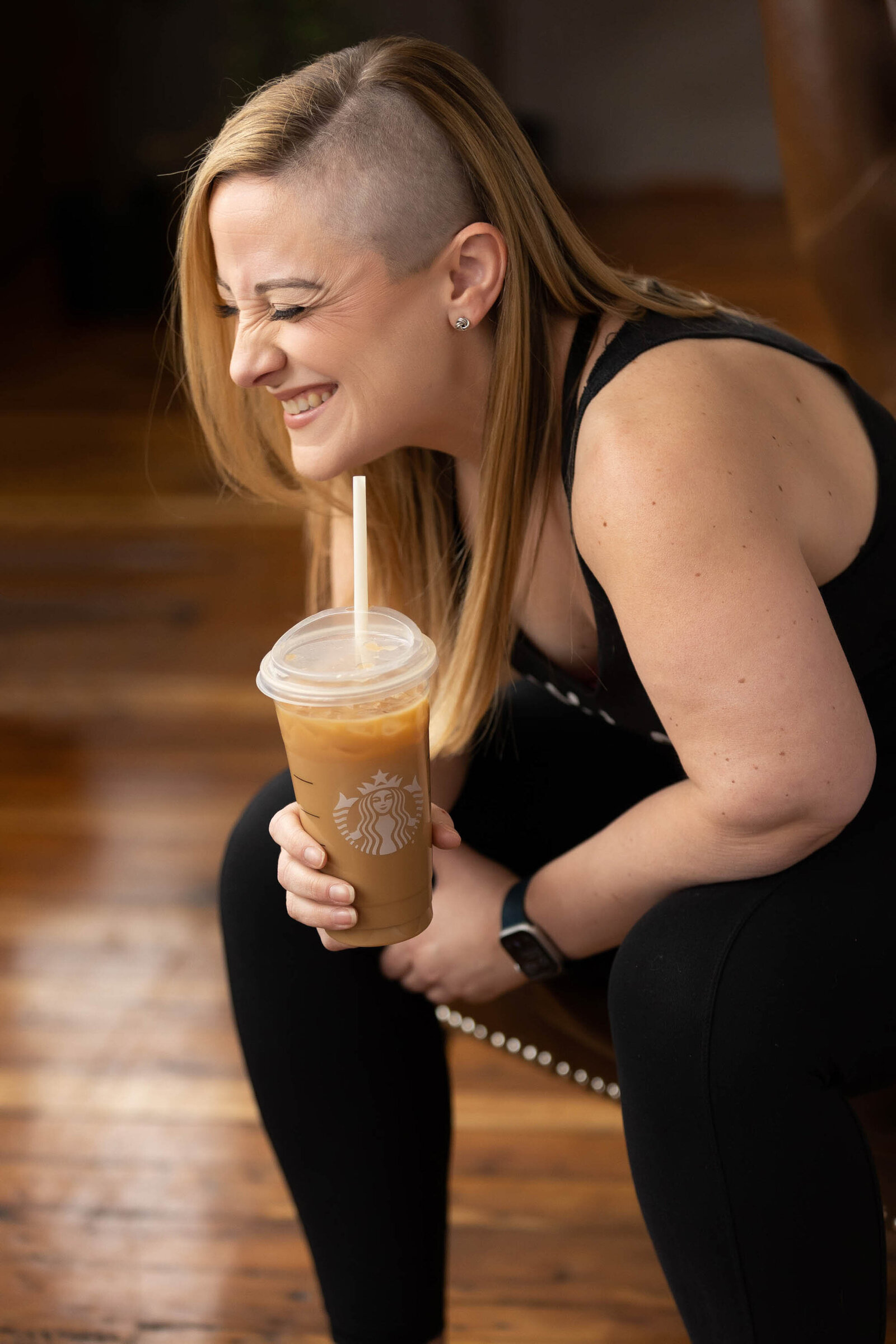 woman sitting while holding her coffee