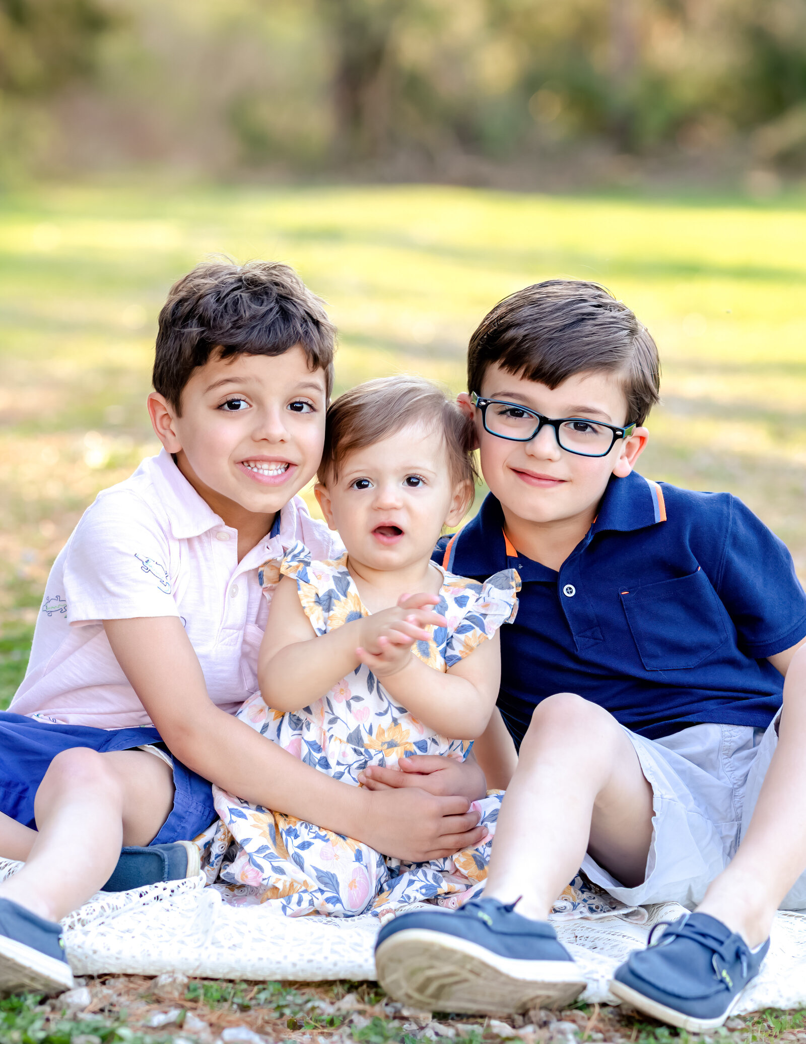 two brothers and their sister hugging for family photos