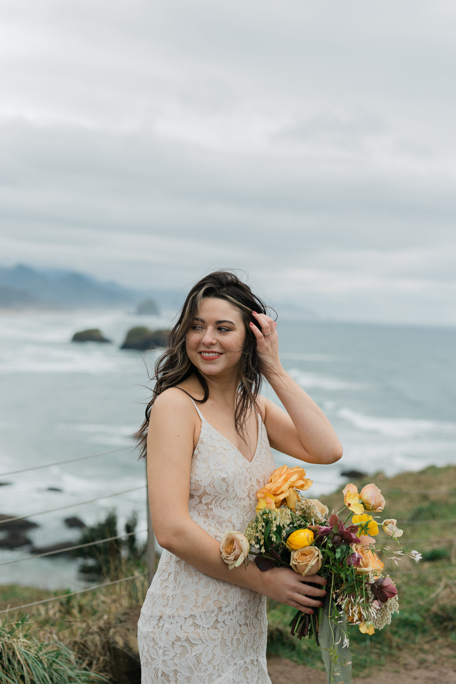 Bride's portrait behind a cloudy scenery with ocean