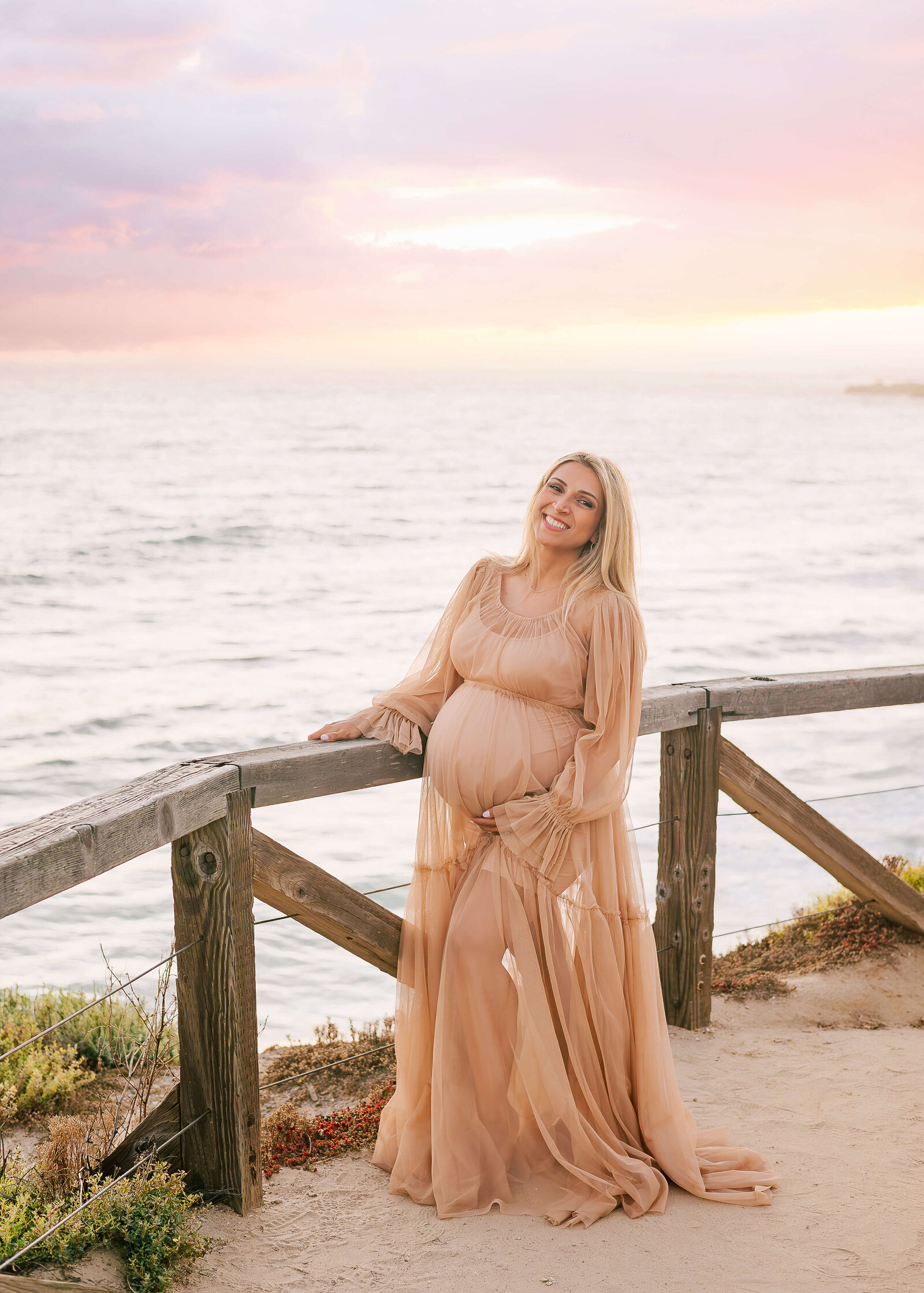 Mama wearing a Reclamation gown at Maternity Session in Crystal Cove.