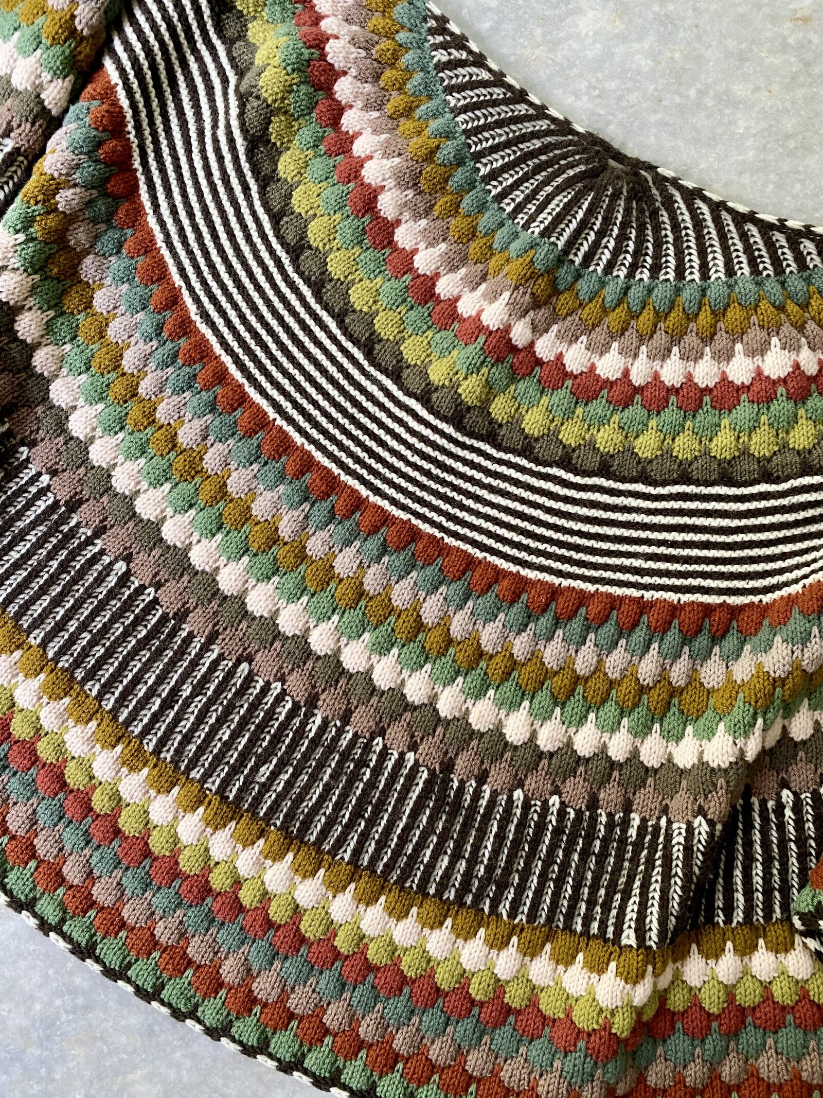 Hand knit shawl with bubble and brioche stitches.