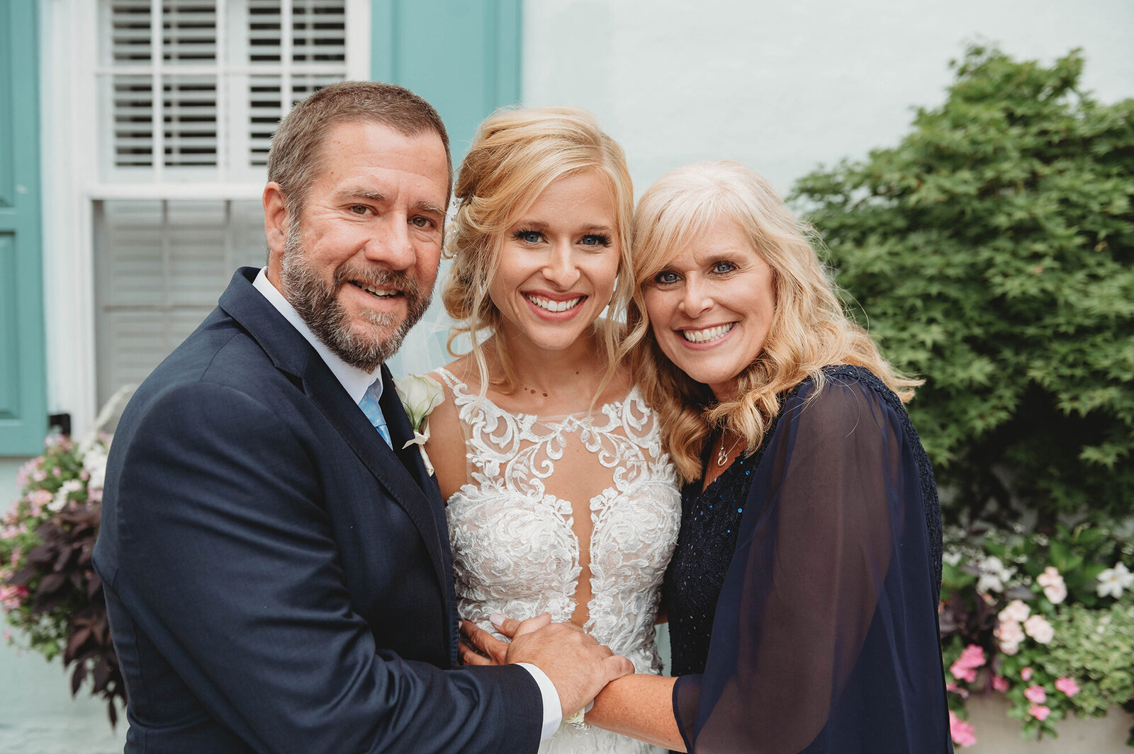Bride poses with her parents after her Micro-Wedding Ceremony in Charleston, SC.