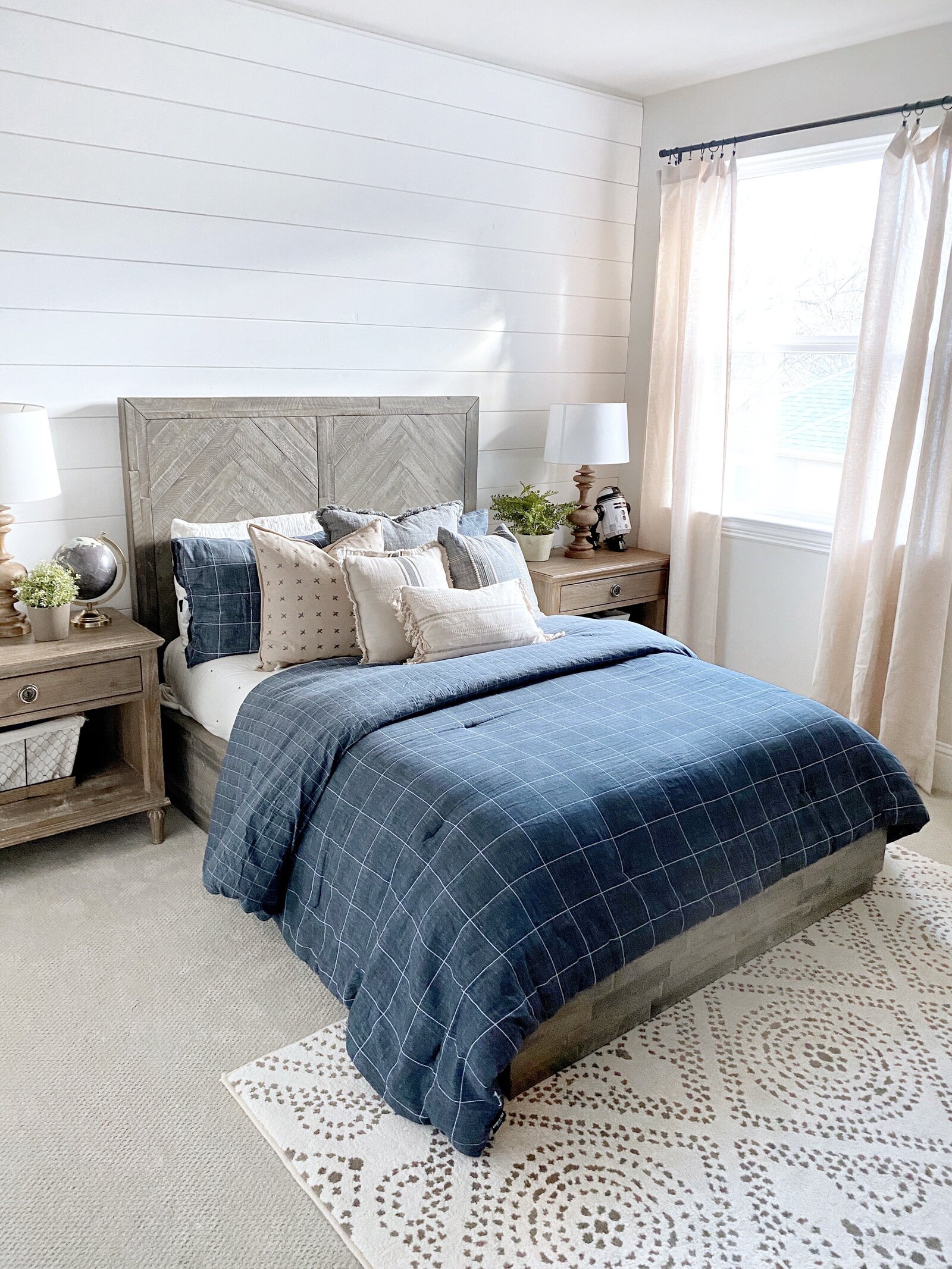 Navy blue bedroom featuring a bed with MTH items
