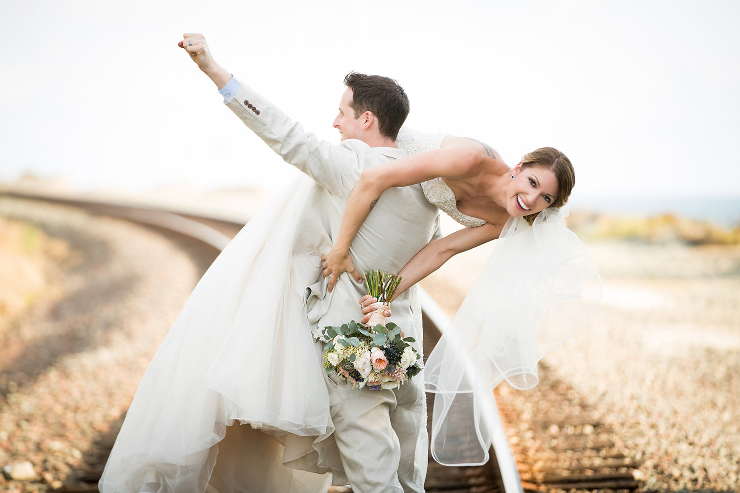 Seagrove Park wedding photos fun couple on train tracks