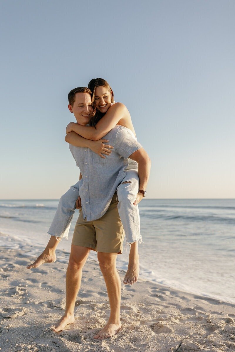 piggy back ride with couple taken by surprise proposal photographer naples