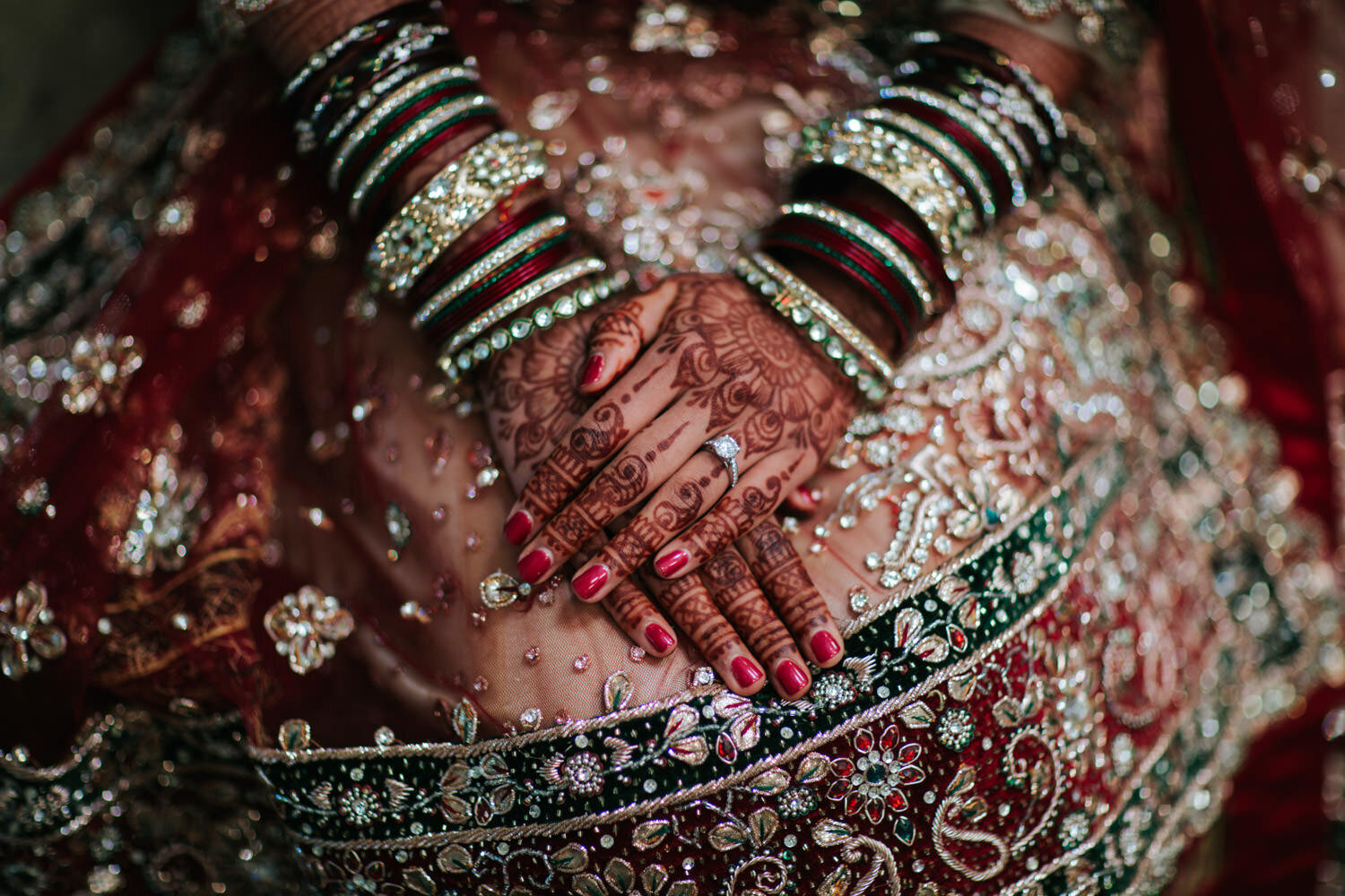 Indian Bride with mehendi hands folded on her lap