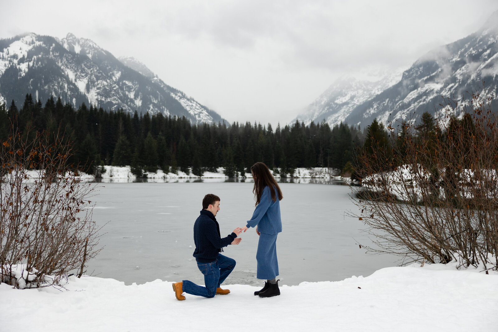 surprise engagement proposal photographed at gold creek pond with beautiful mountain and water views