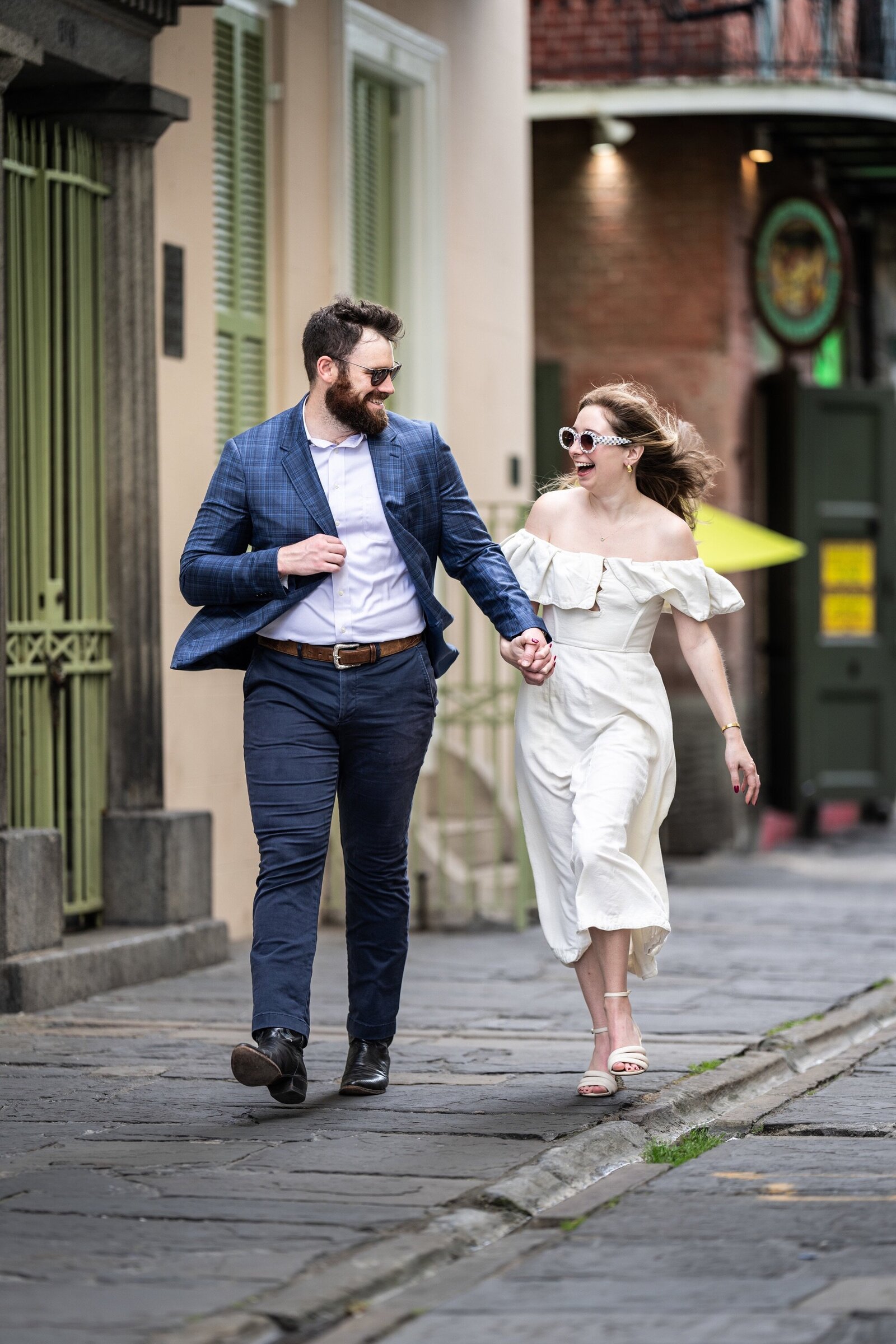 Couple walking in Pirates Alley on a windy day