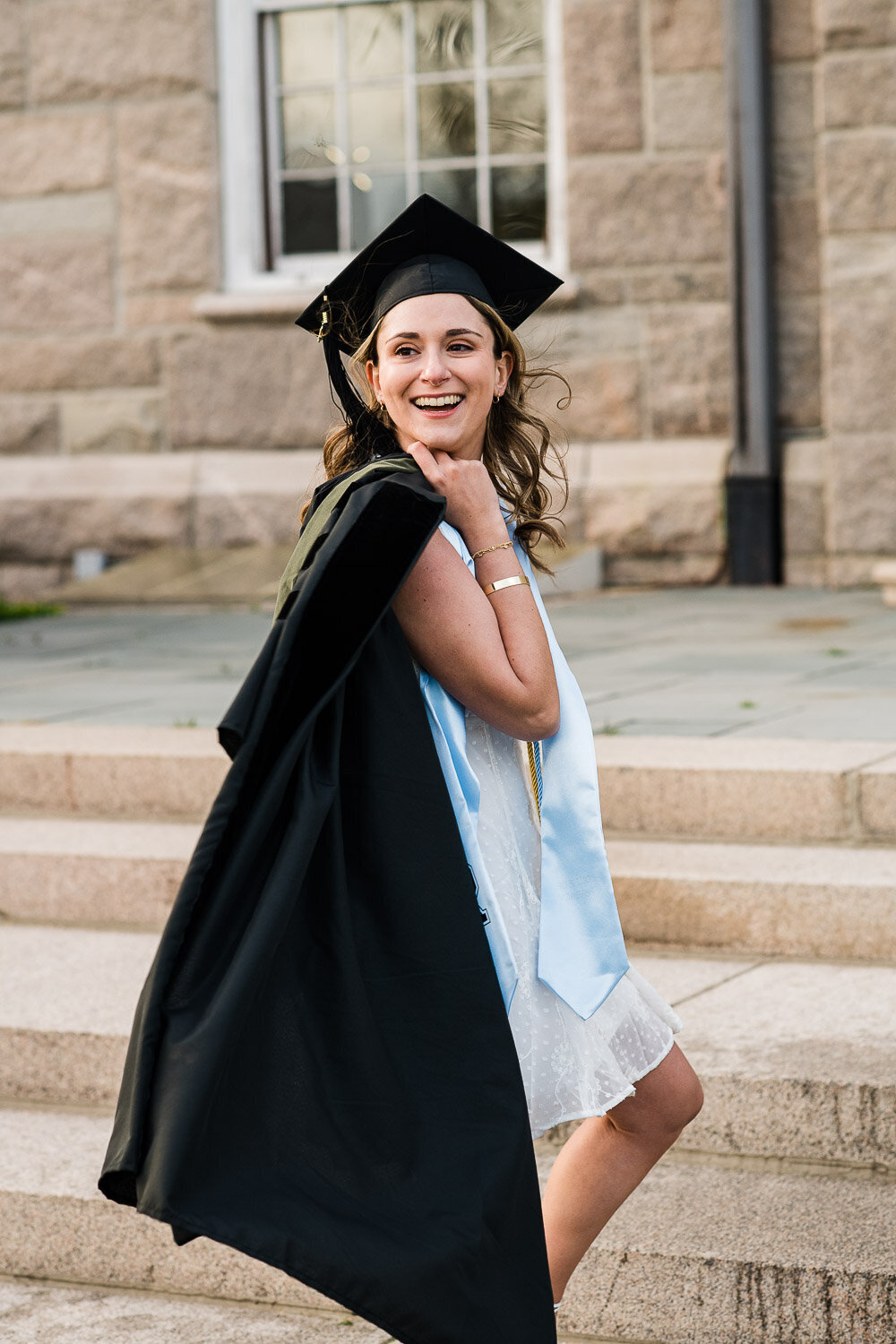 grad girl in cap with robe over shouldder