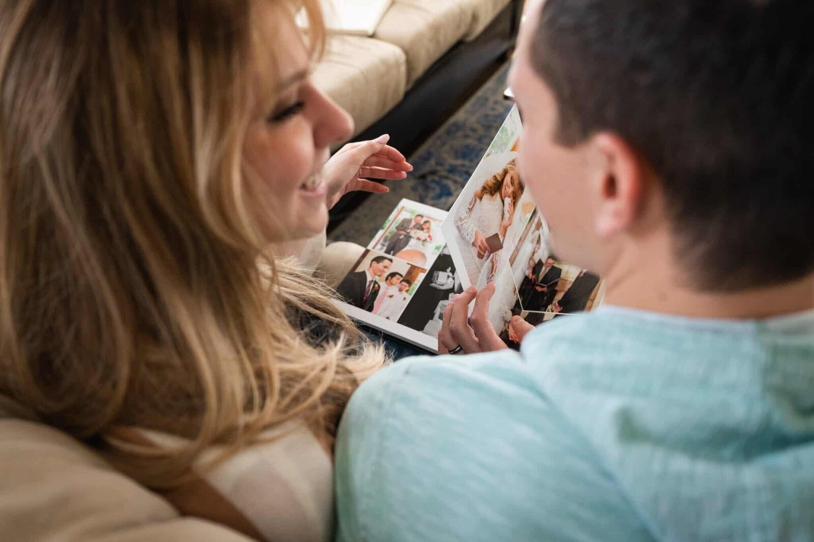 Couple sharing a moment while looking at their wedding album.