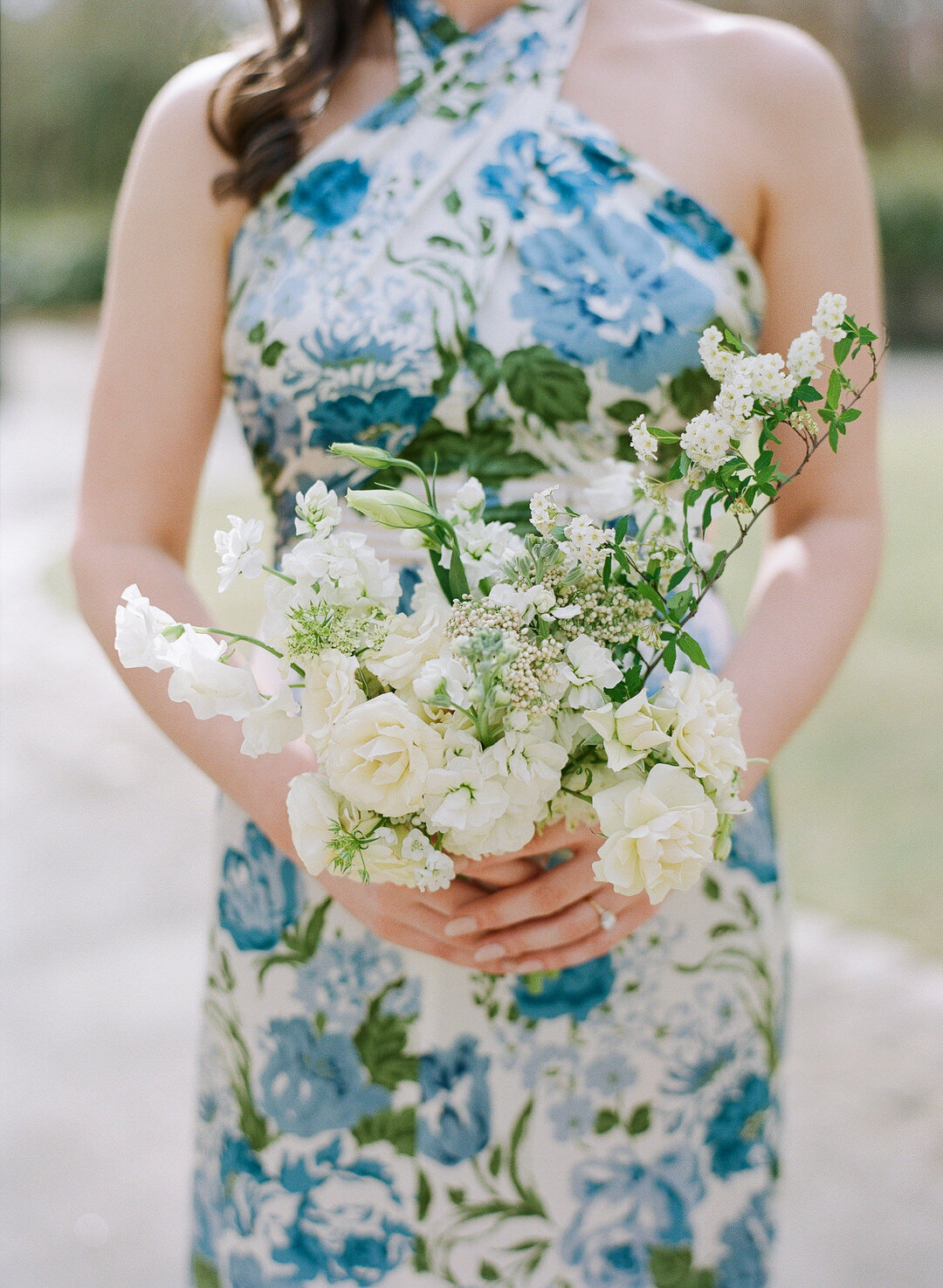 Maid of Honor in Blue floral dress holding bouquet