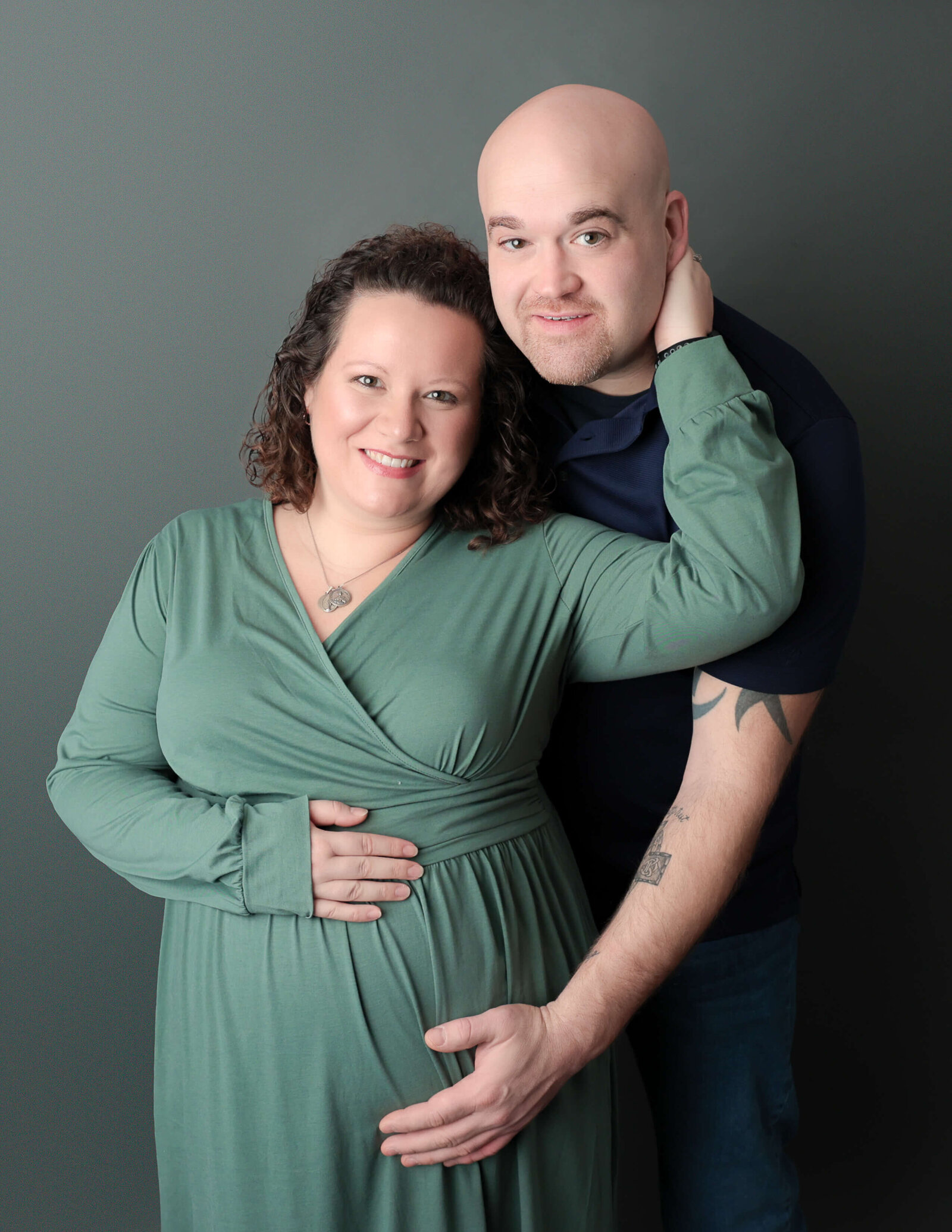 Maternity couple posed at our Rochester, NY studio.
