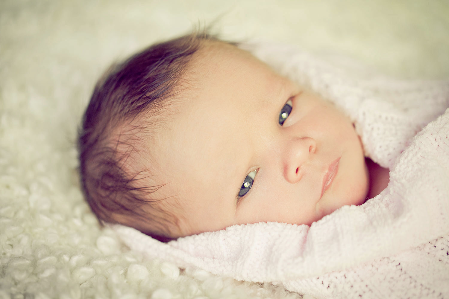 san diego newborn photographer | newborn with big blue eyes and a sweet pink blanket