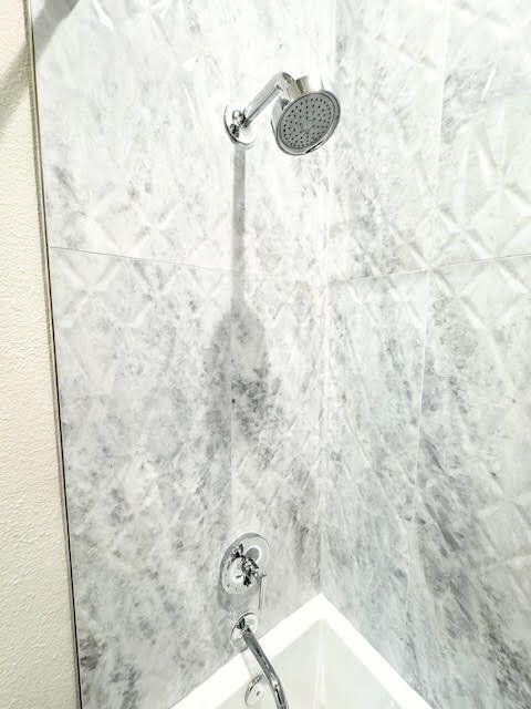 Experienced renovation design services showcased in a luxurious bathroom with an elegant freestanding tub and sophisticated decor.