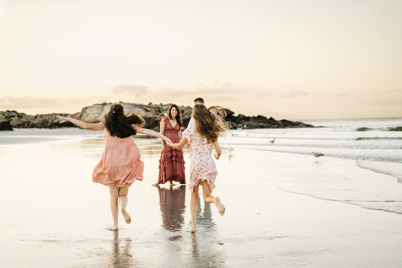 teen daughters run on beach