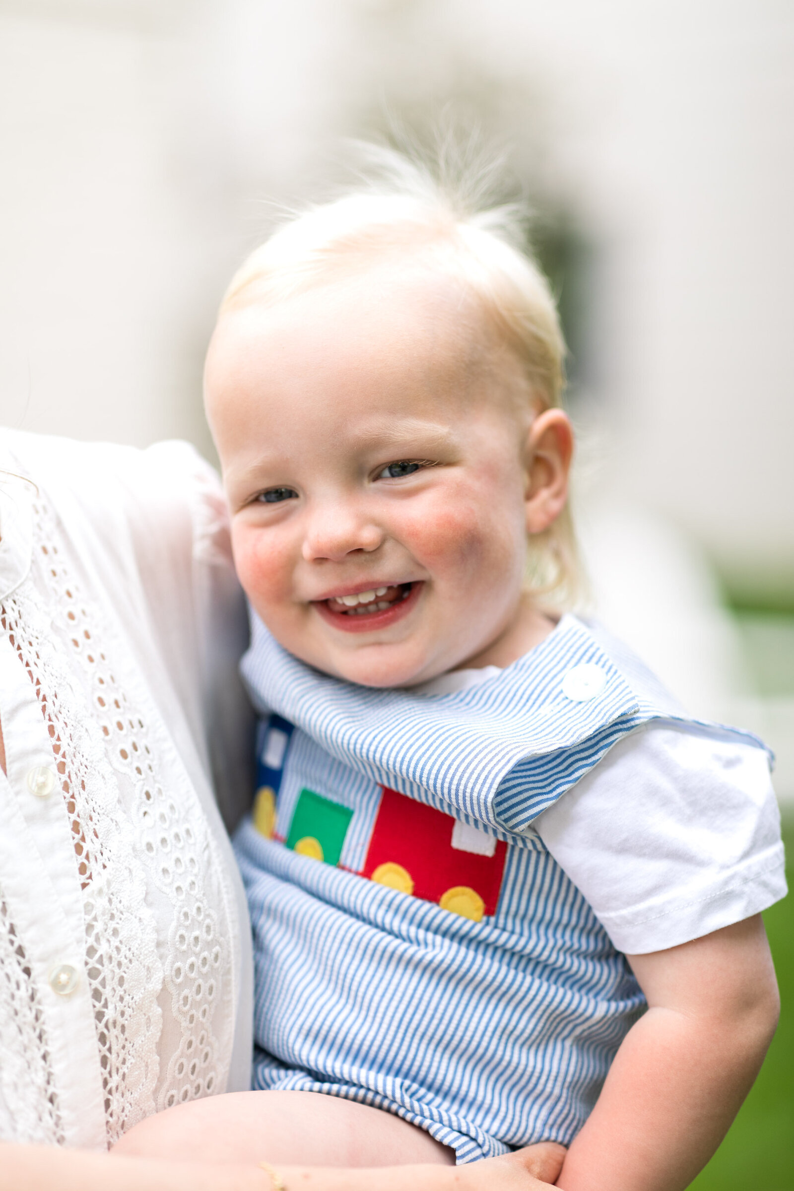 Kansas_City_Family_Photographer_baby_in_mothers_arms_train_shirt_smiling-83
