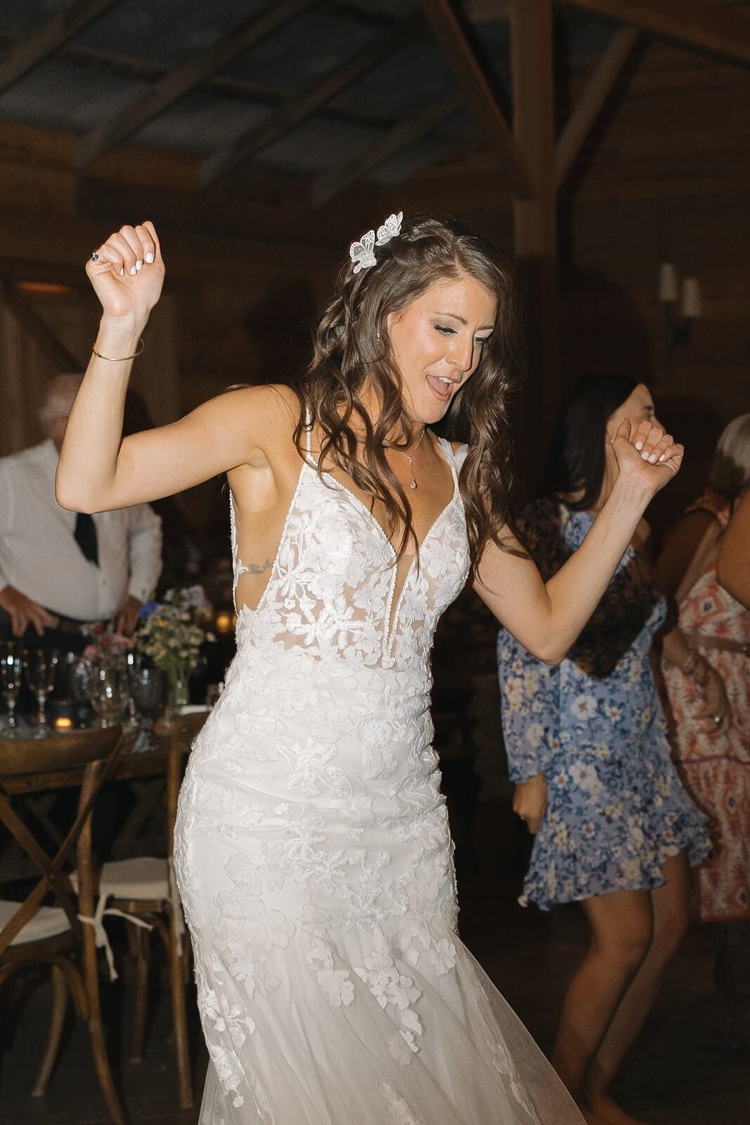 Bride dancing with her arms up on the dance floor