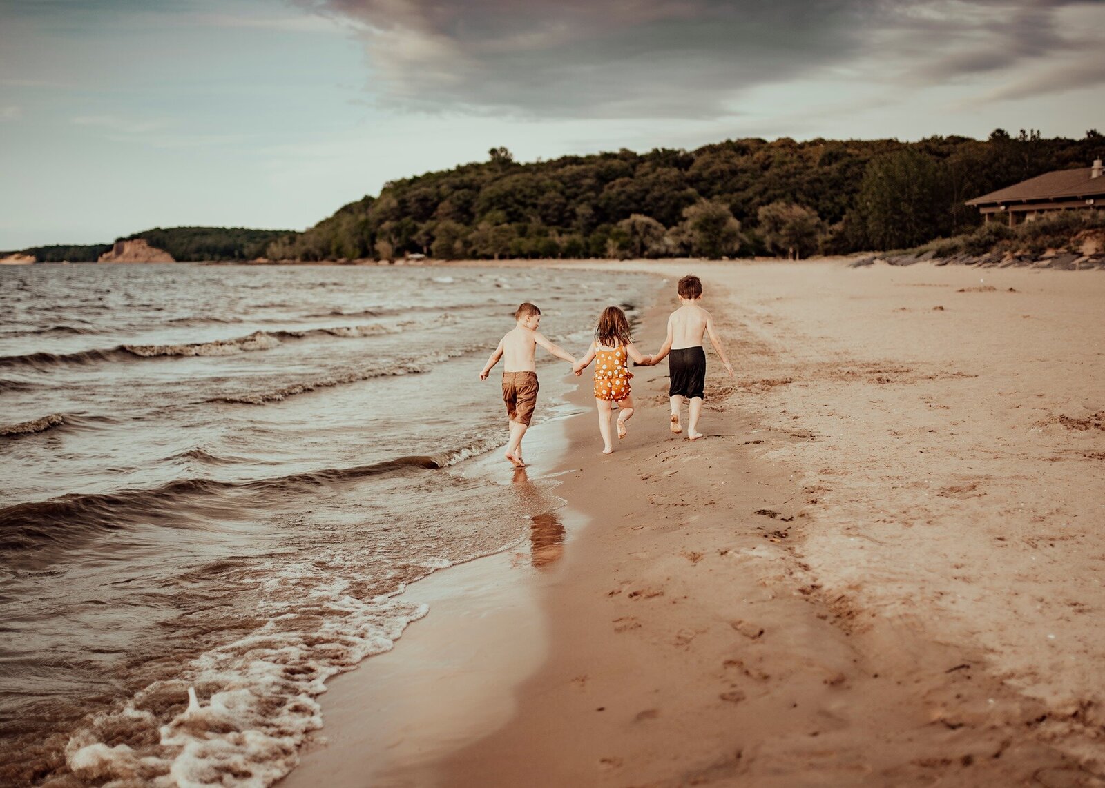 kids having fun running on the beach in oswego county NY