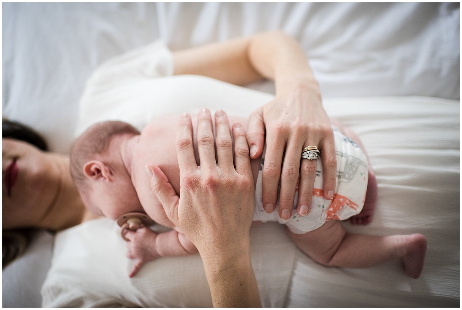 Newborn baby laying on mom on bed lifestyle newborn photoshoot Emily Ann Photography Seattle Photographer