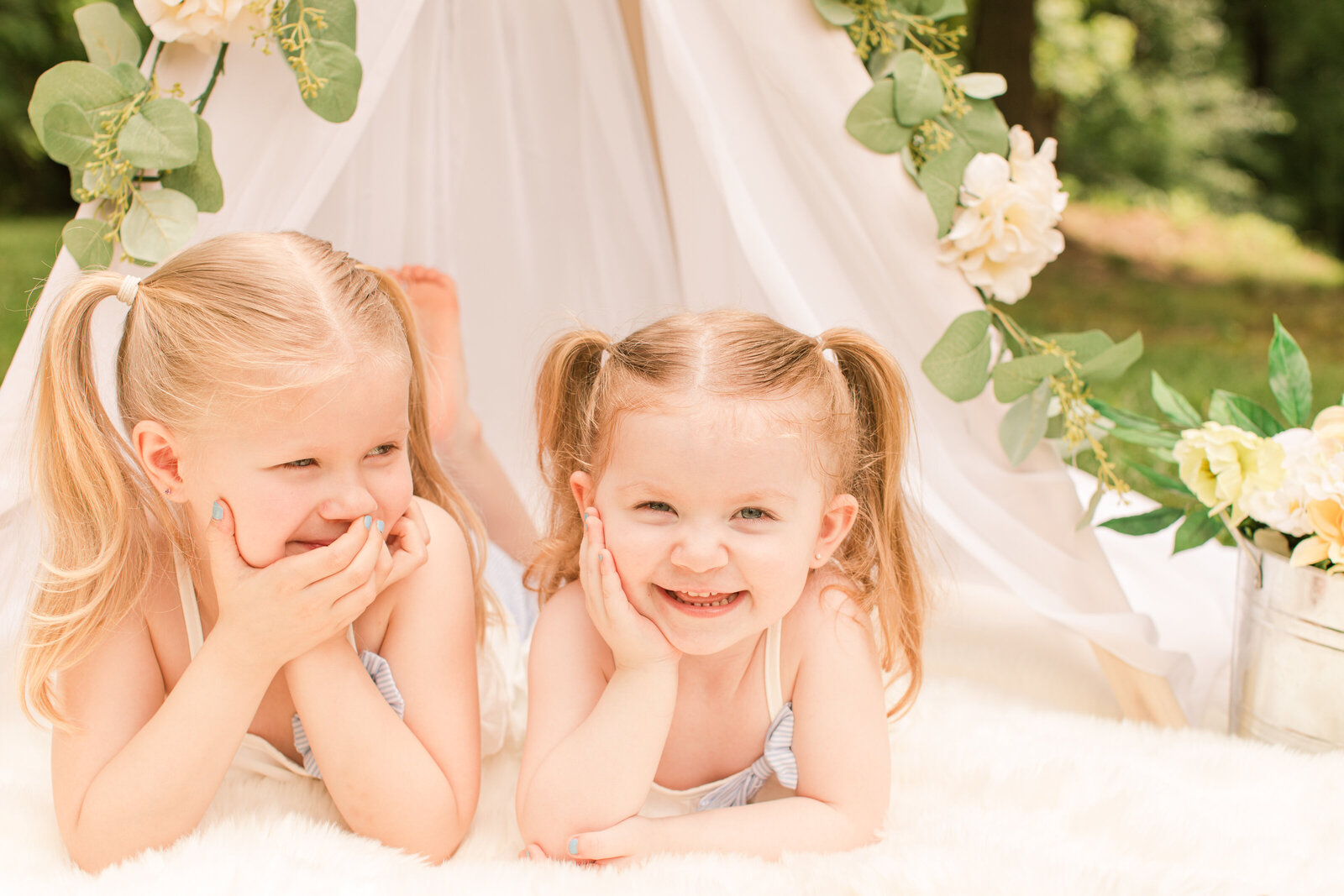 sisters side by side laughing at each other