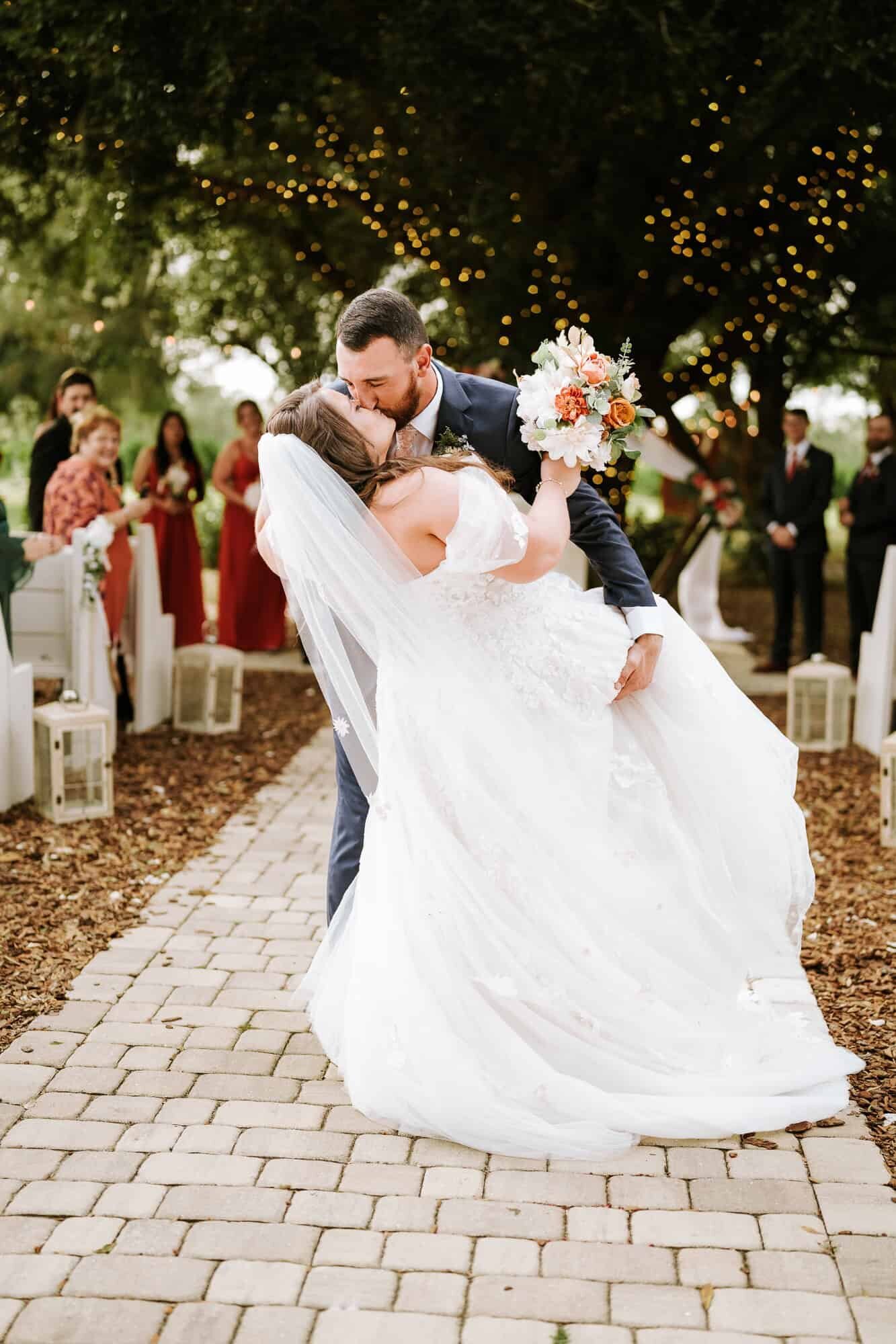 dip kiss after the I do at Ever After Farms Citrus Barn wedding
