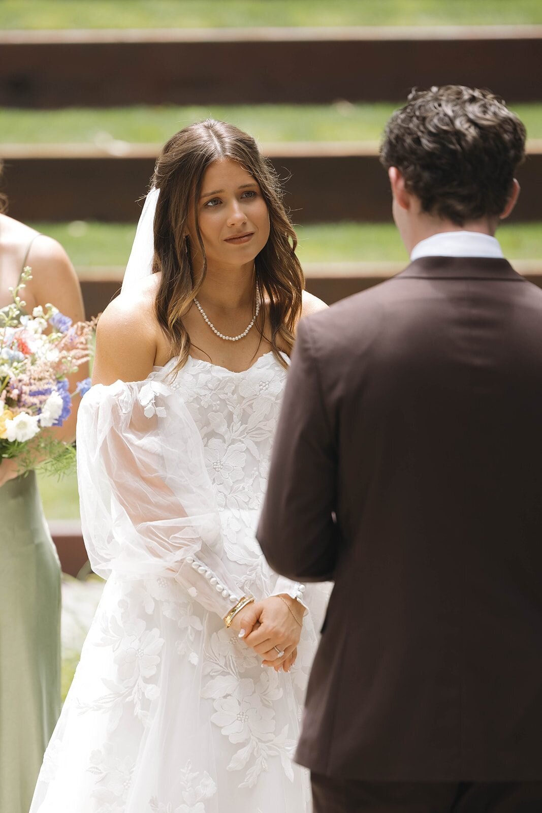 Bride smiling at the groom during their vows