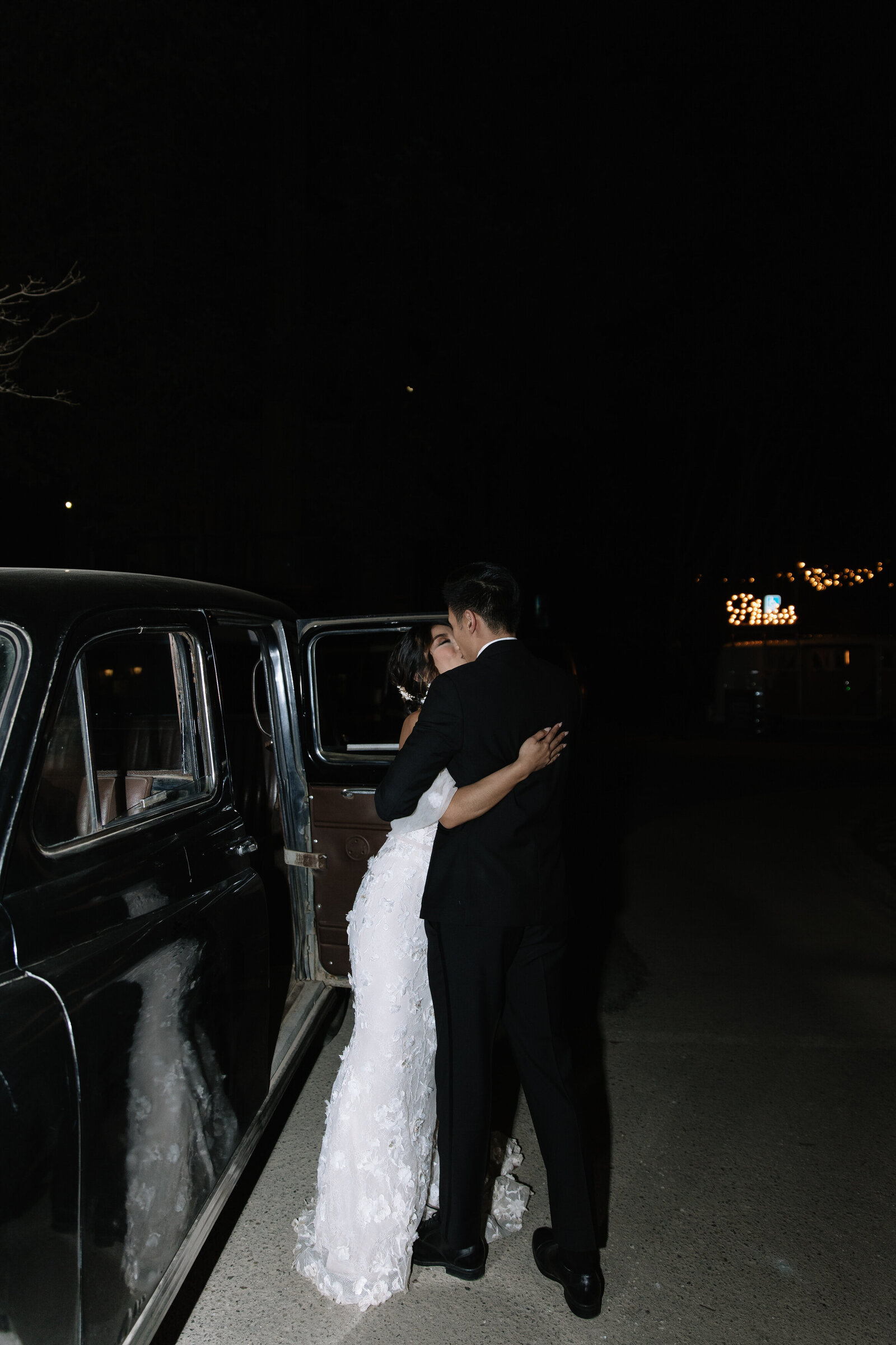 Couple embrace outside of classic car during Seattle elopement