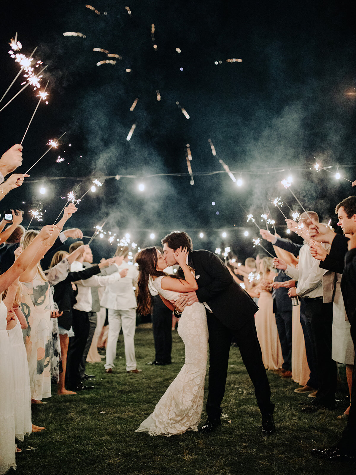 Couple kissing during a firework sparkler exit after an Allenbrooke Farms wedding