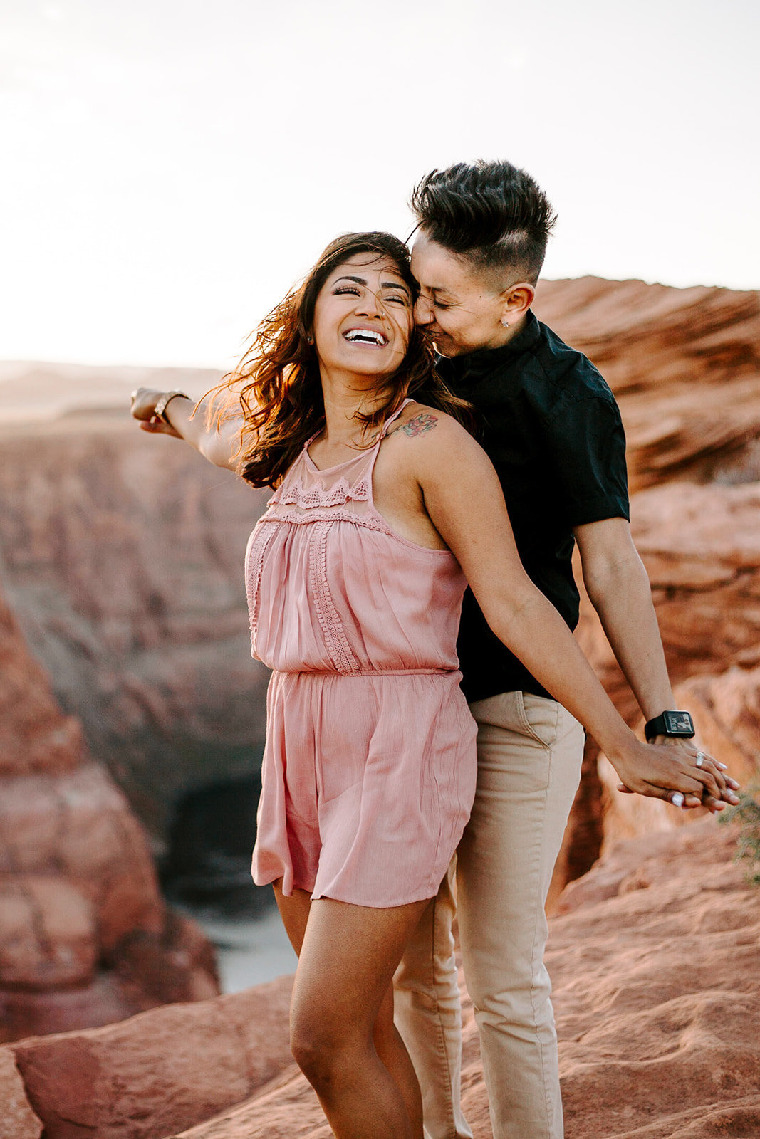 Couple holding hands smiling at each other during their Arizona engagement