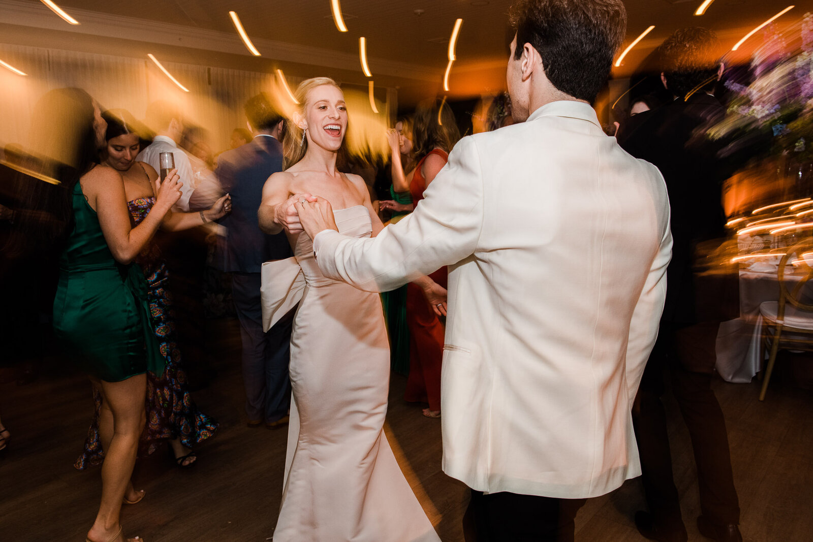 bride and groom dancing with streaming light