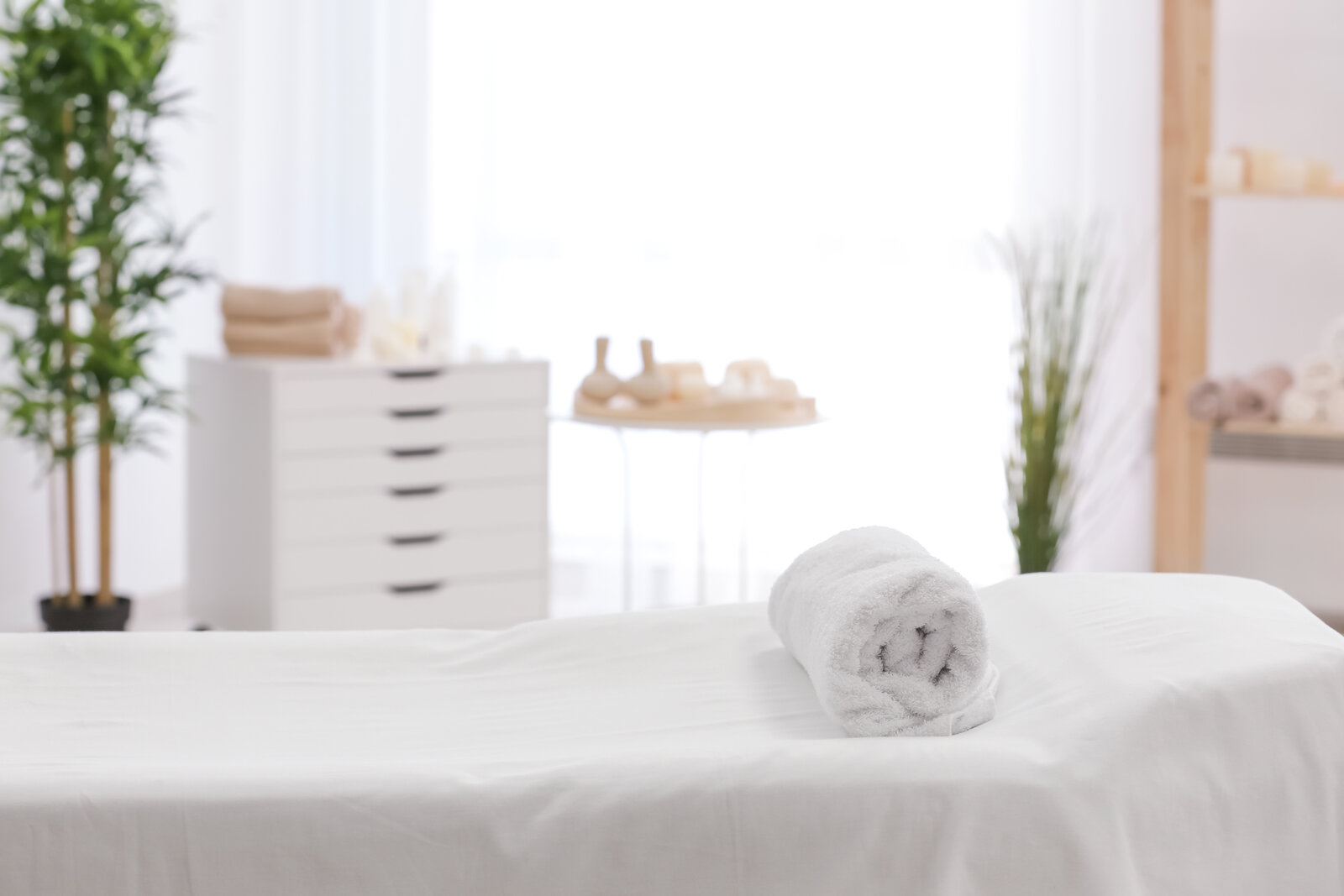 Bright and clean treatment room at Needle Point Therapy featuring a massage table with a rolled towel, ready for dry needling or therapeutic care