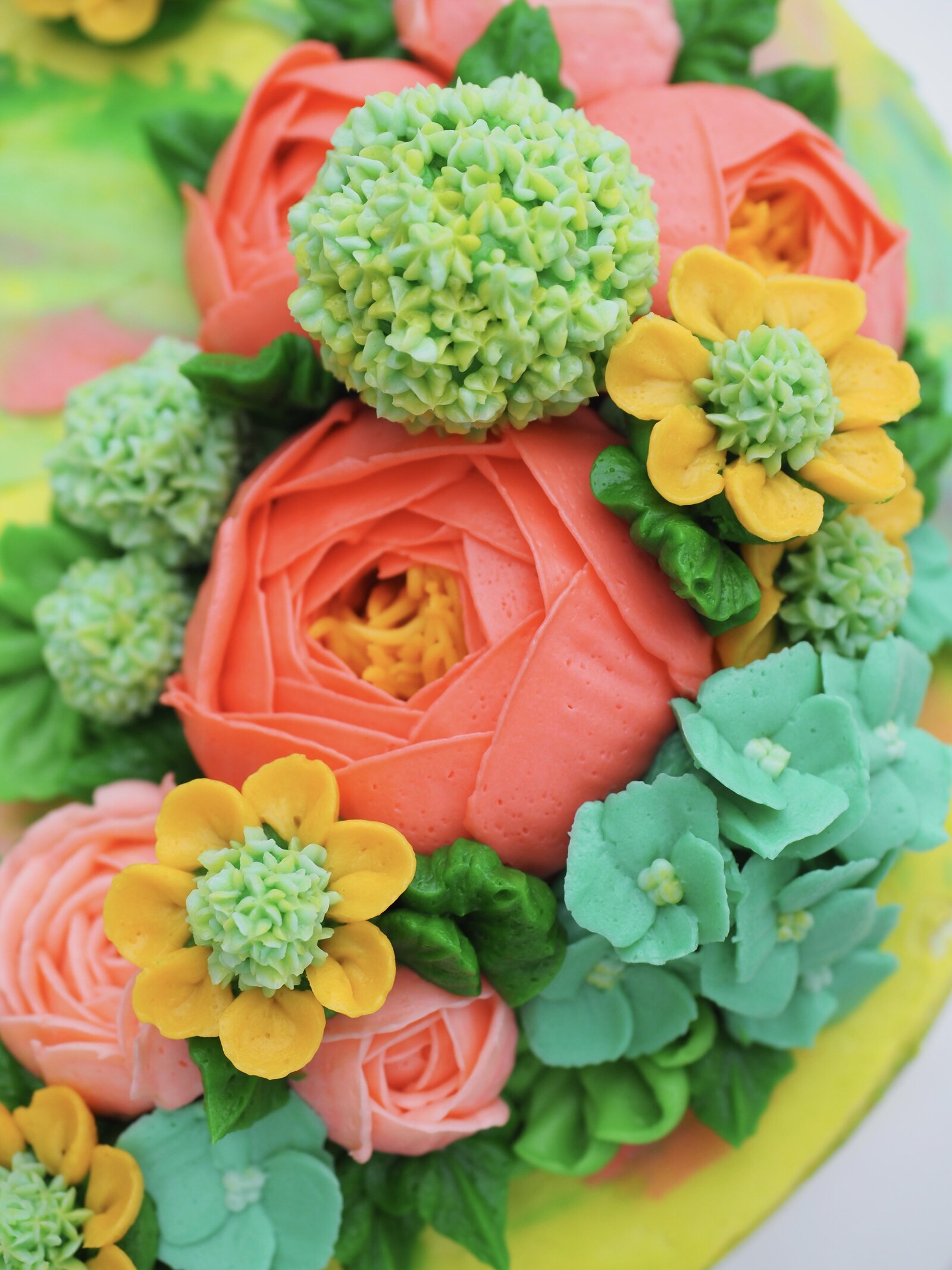 Neon colored buttercream flowers on a cake
