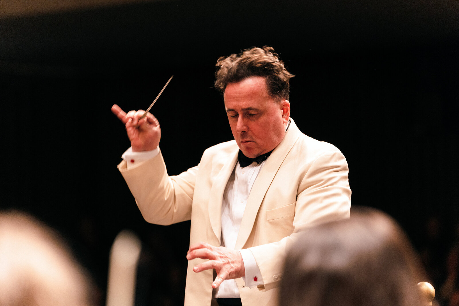 Orchestra Conductor is lost in the moment during a performance