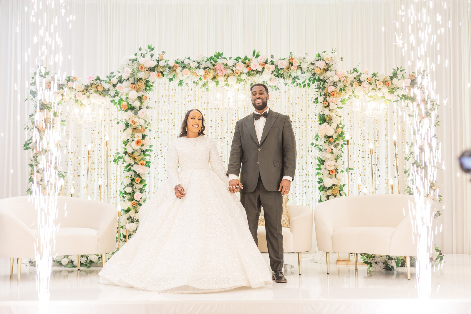 Bride and groom on stage inside wedding venue