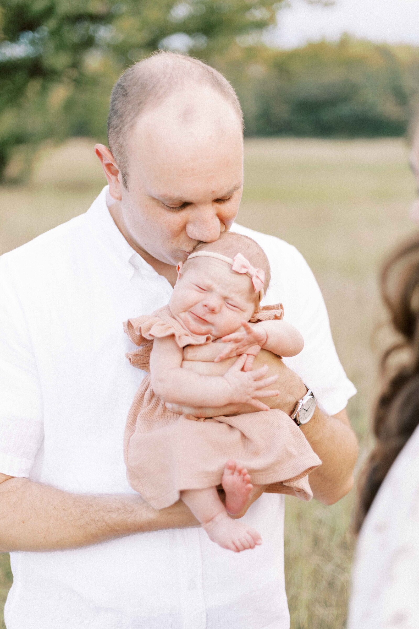 dad holding newborn baby in peoria illinois newborn photos 