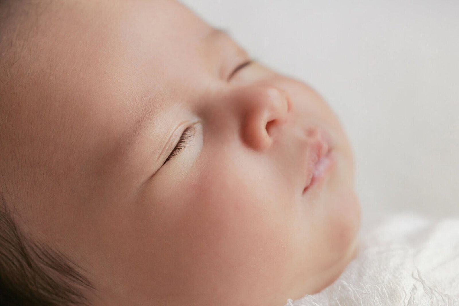 Closeup of sleeping newborn baby at San Francisco Bay Area newborn photography studio.