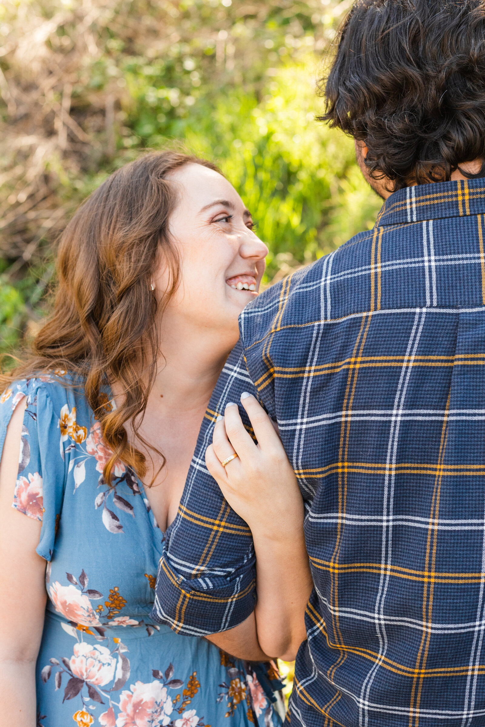 An engaged couple poses for photos in a garden in Los Angeles, Ca.