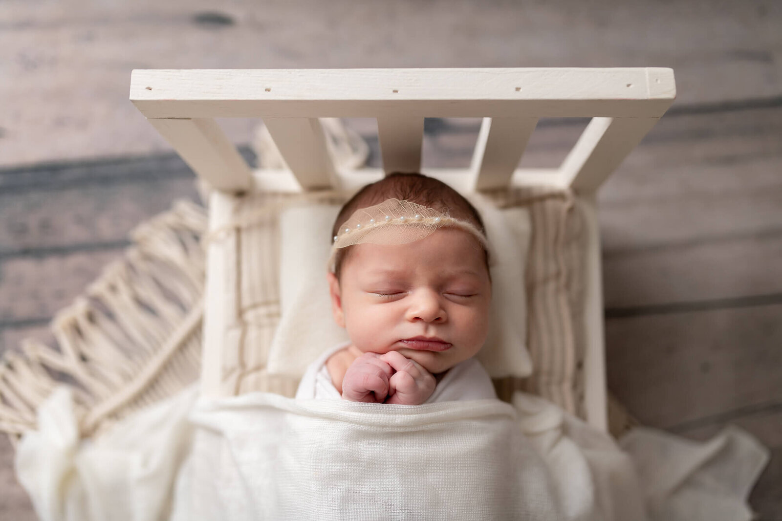 top-down newborn portrait of baby laying in bed