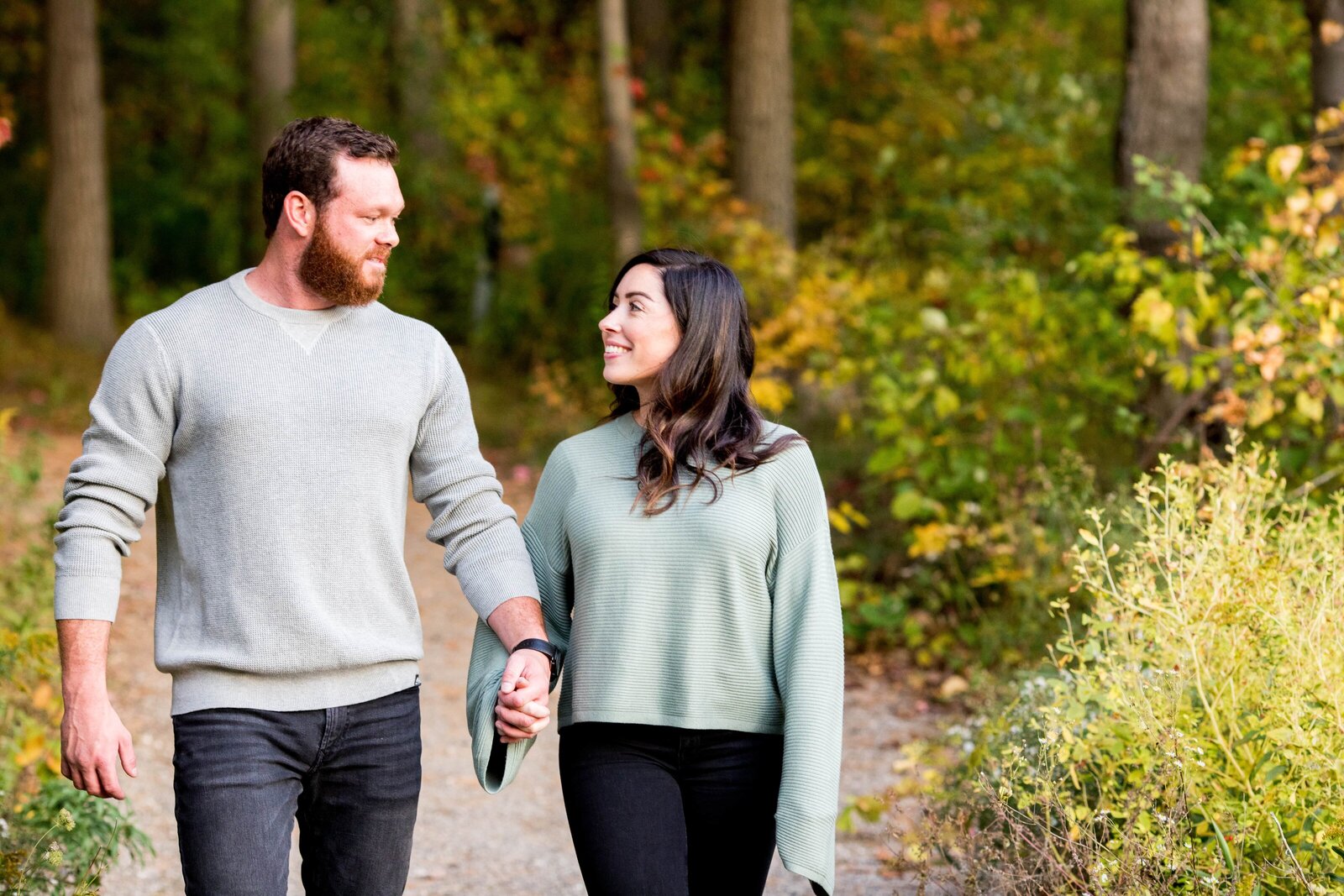 Couple looking at each other during fall engagement session.