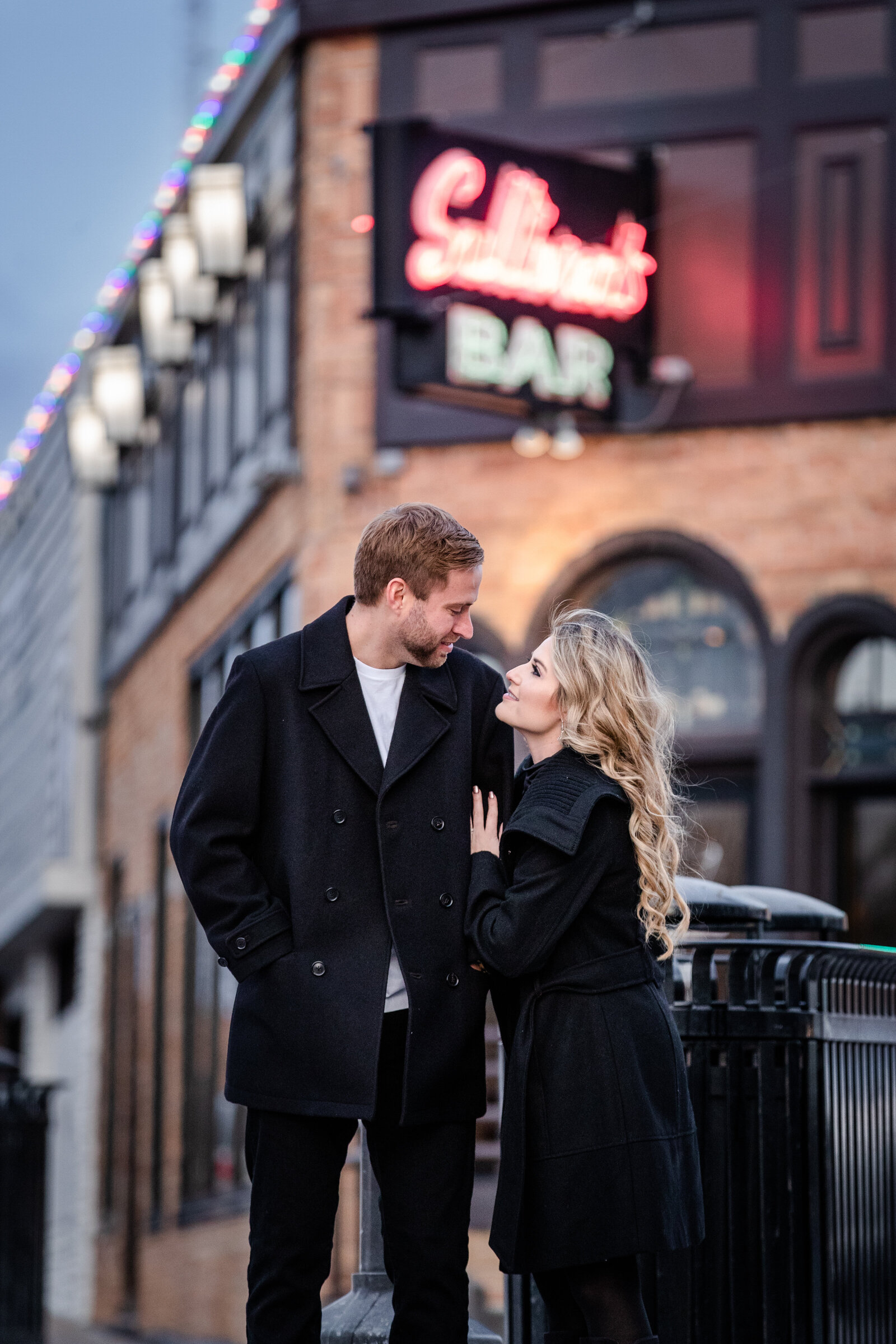 Couple with neon sign in background